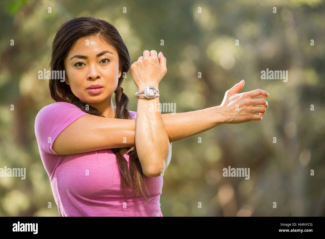 Portrait of Asian woman stretching arms Stock Photo - Alamy