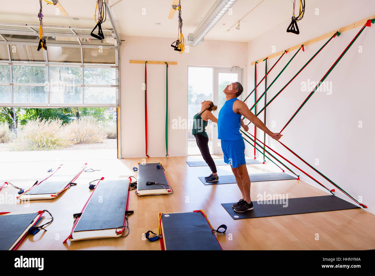 People using resistance bands in gymnasium Stock Photo
