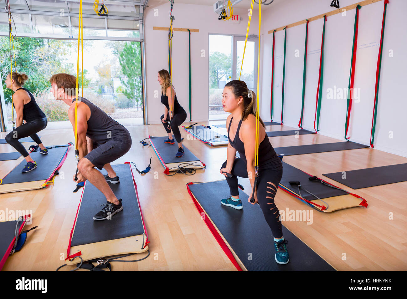 People using resistance bands in gymnasium Stock Photo