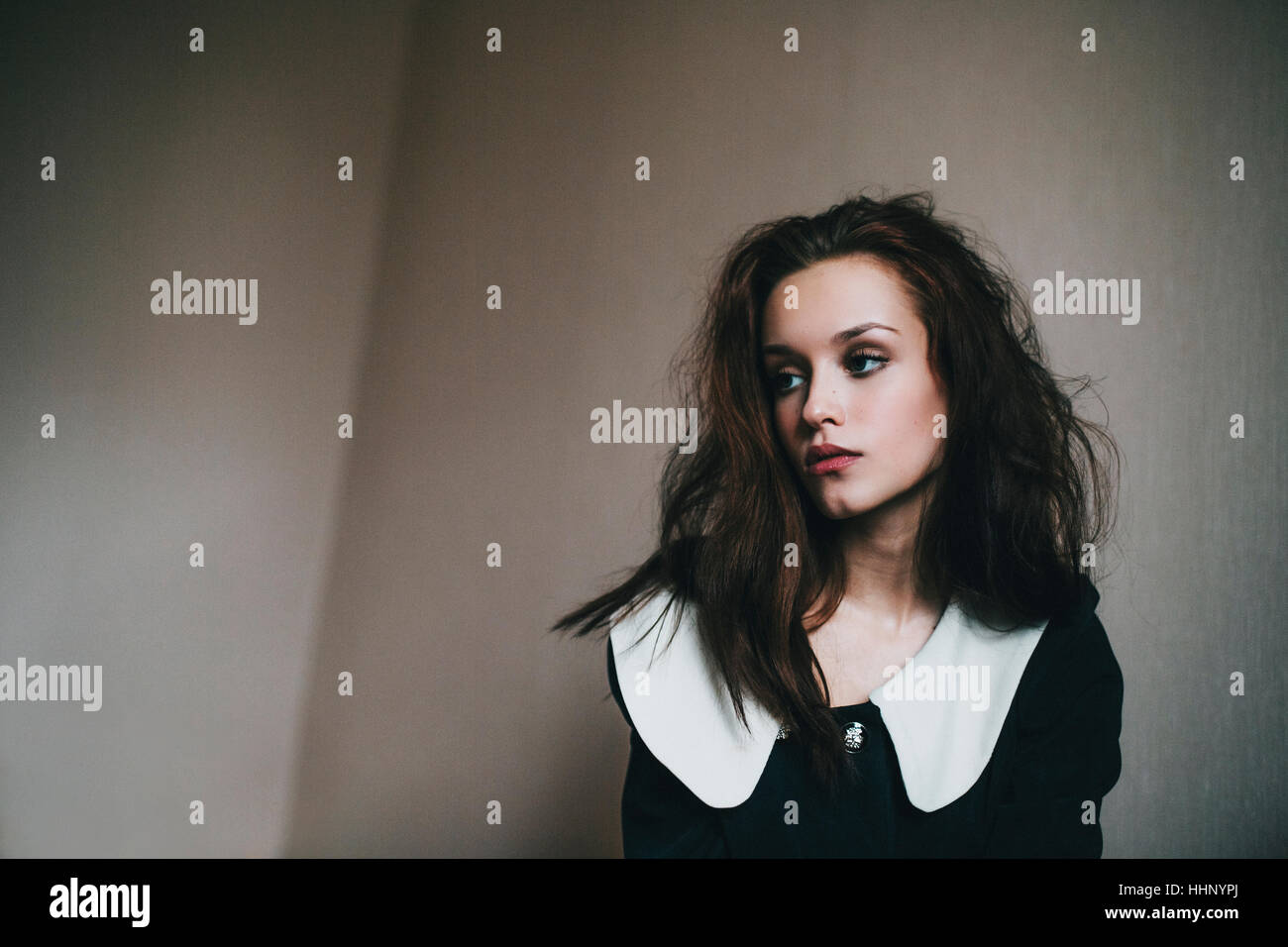 Portrait of Caucasian woman with messy hair near wall Stock Photo - Alamy