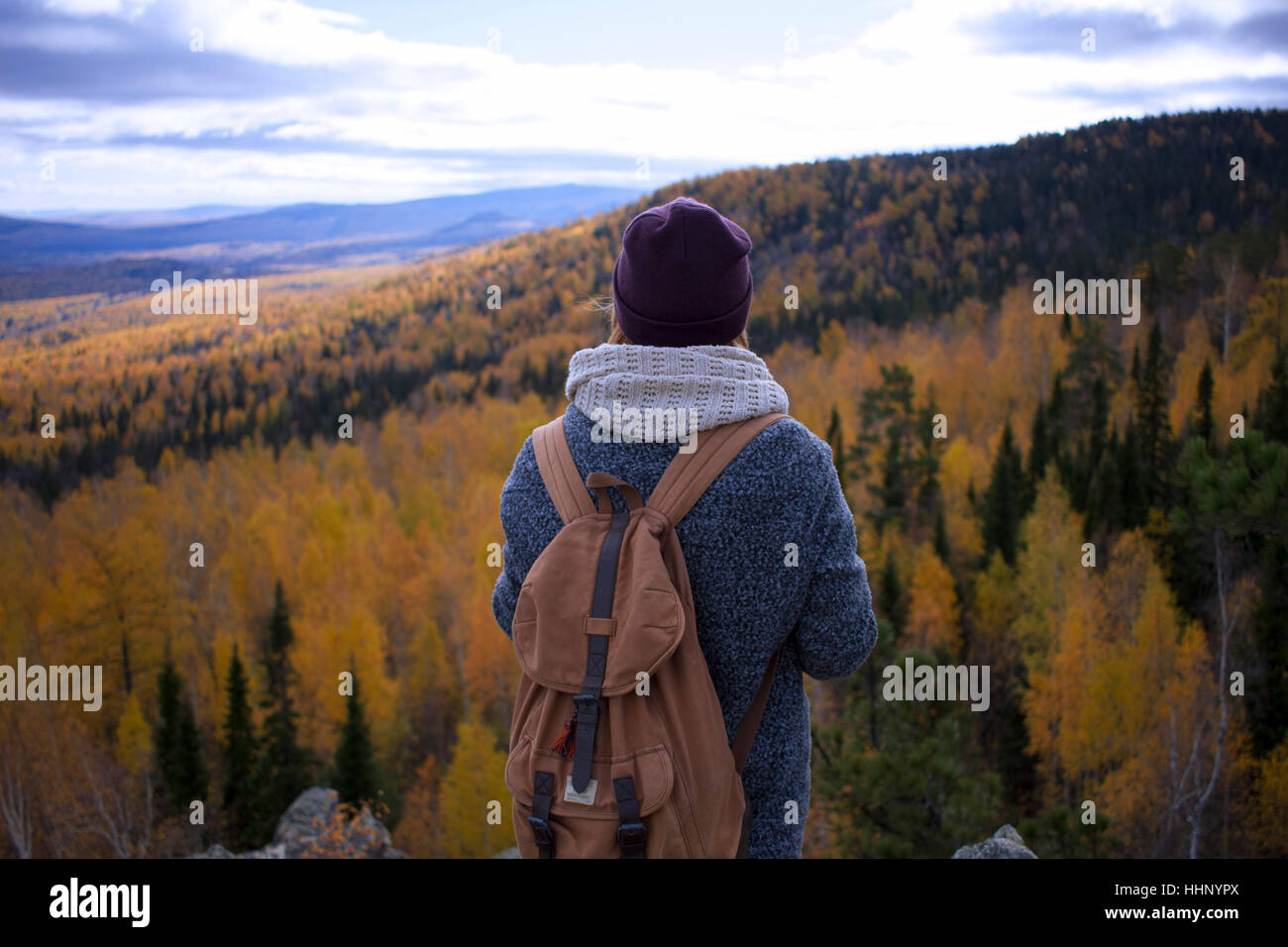 Caucasian woman backpacking in autumn landscape Stock Photo