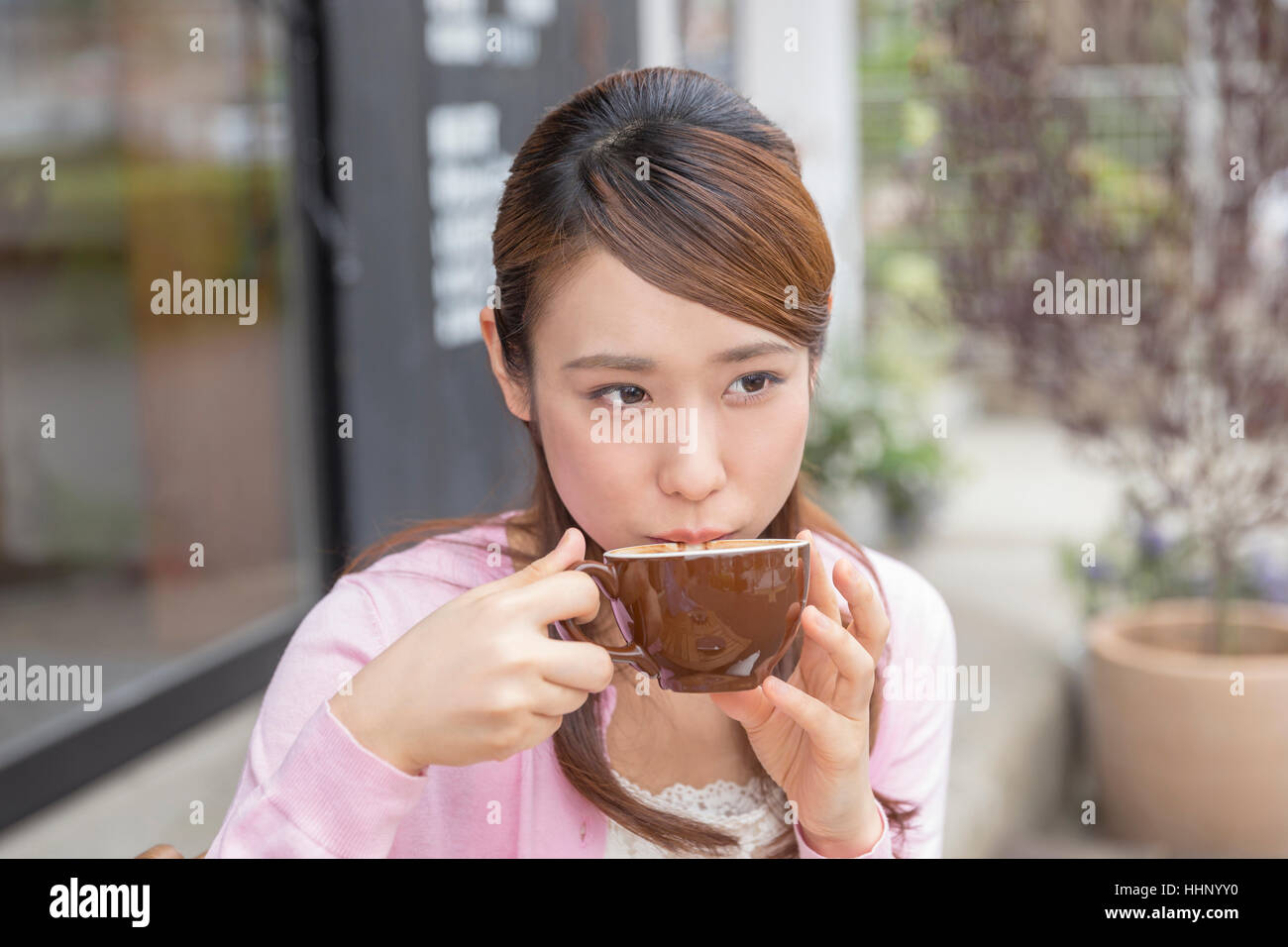 Woman Sitting in the Chair and Having Coffee Stock Photo