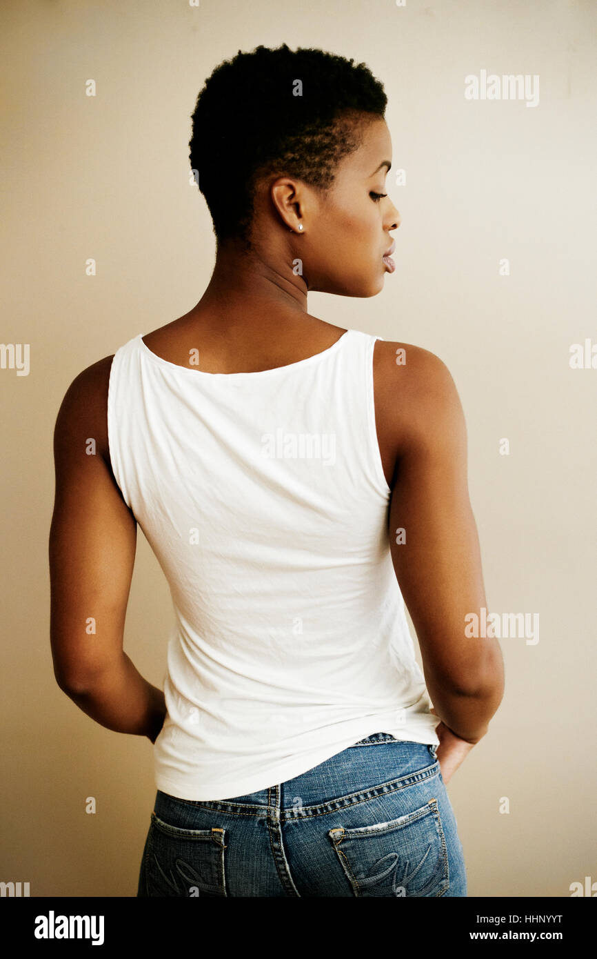 Rear view of Black woman looking over shoulder Stock Photo