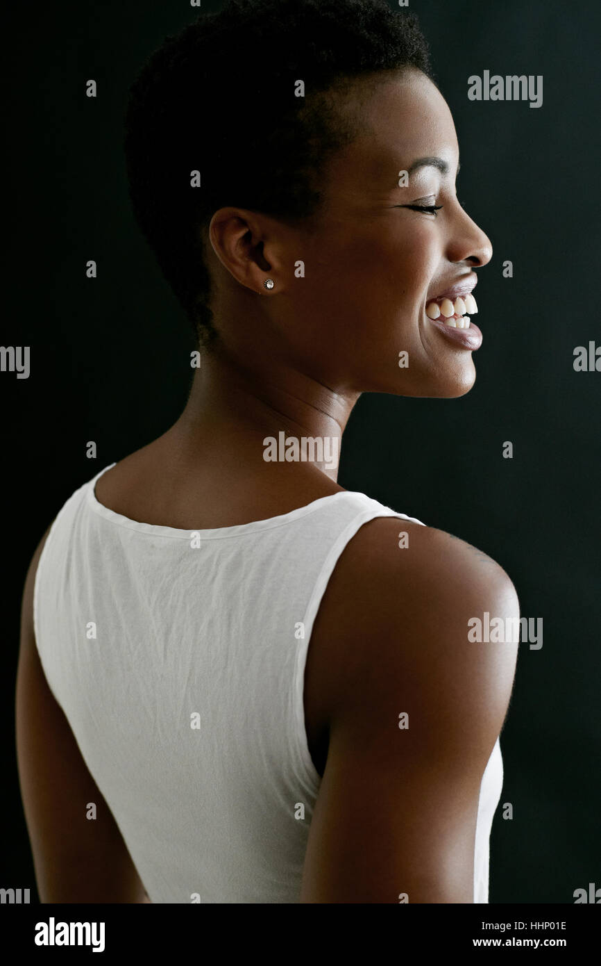 Profile of laughing Black woman Stock Photo