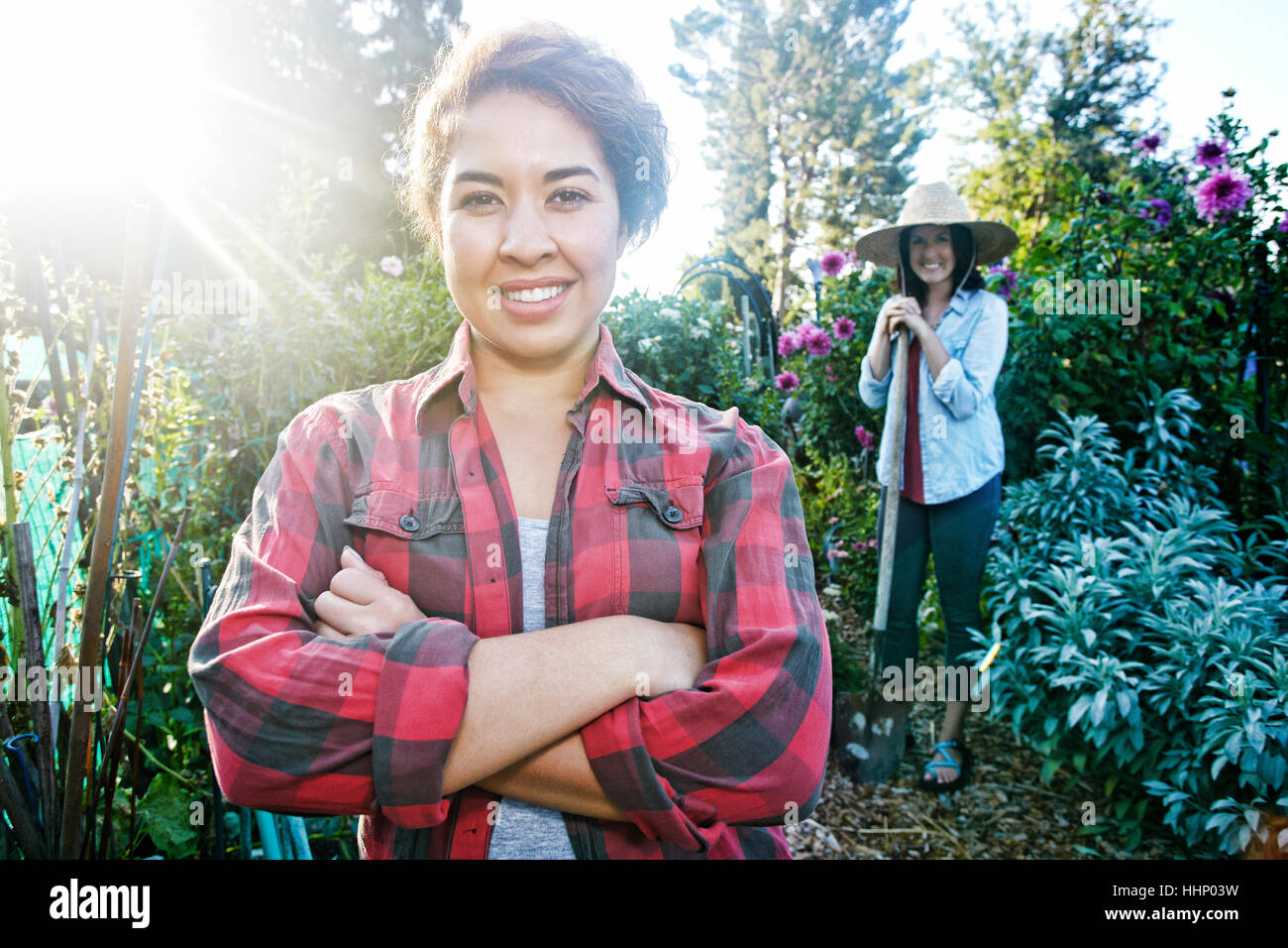 Smiling women posing in garden Stock Photo - Alamy