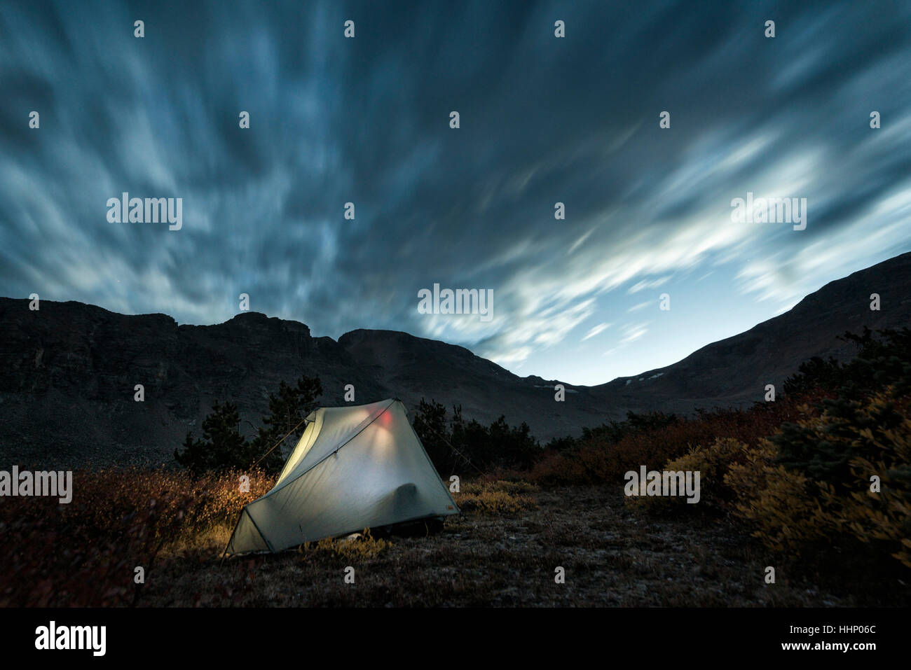 Illuminated camping tent under cloudy sky Stock Photo - Alamy