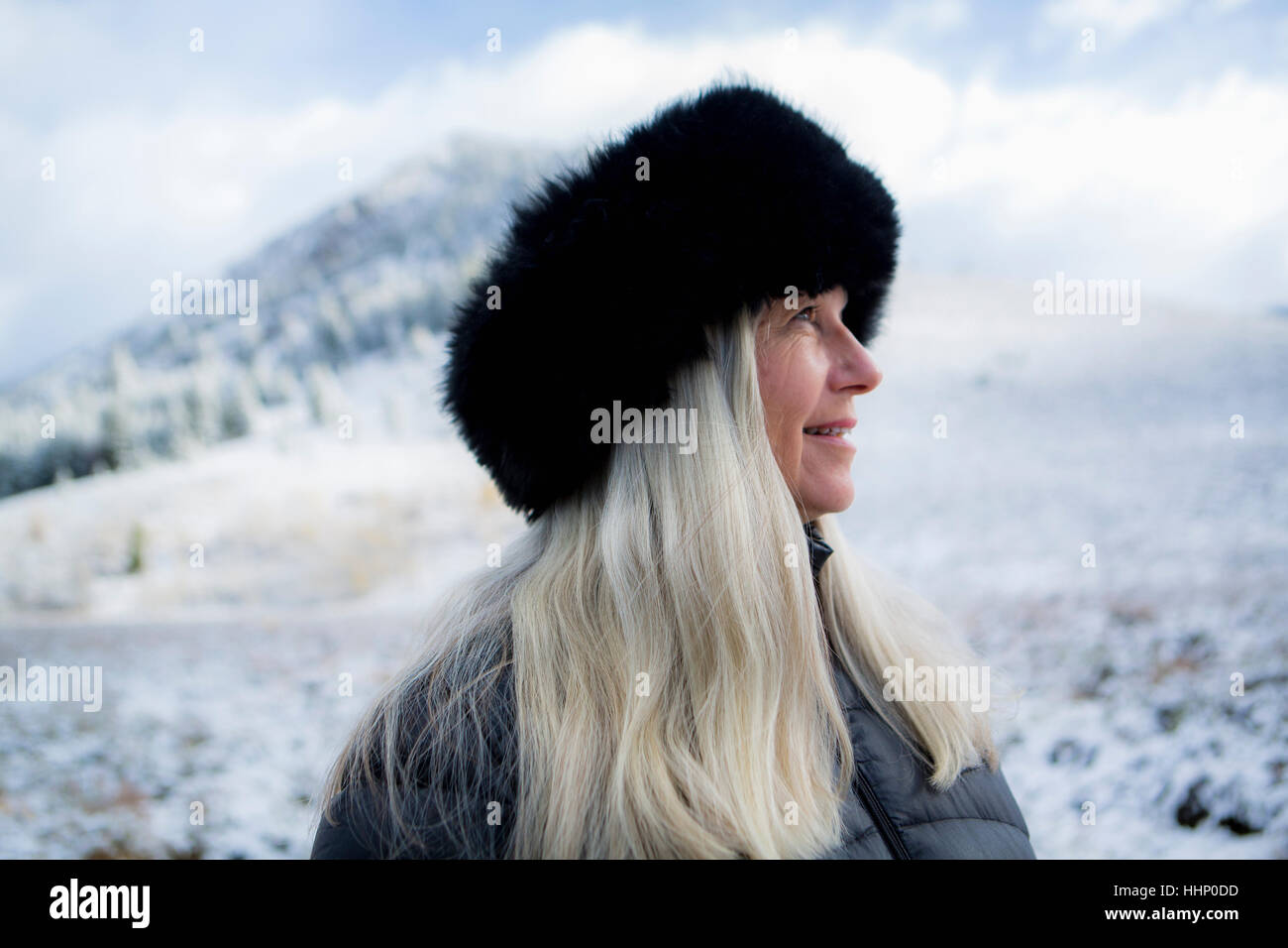 Caucasian woman wearing fur hat in winter Stock Photo