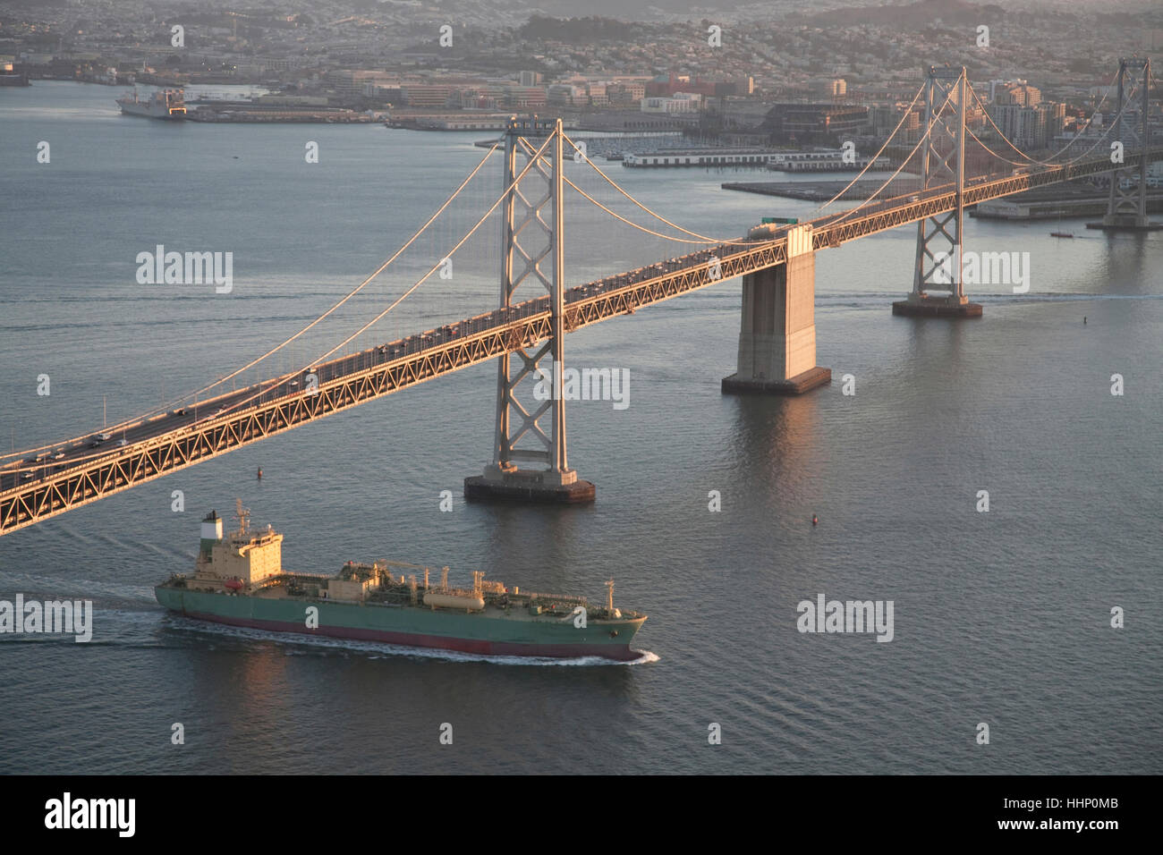 Aerial view of freighter under urban bridge Stock Photo