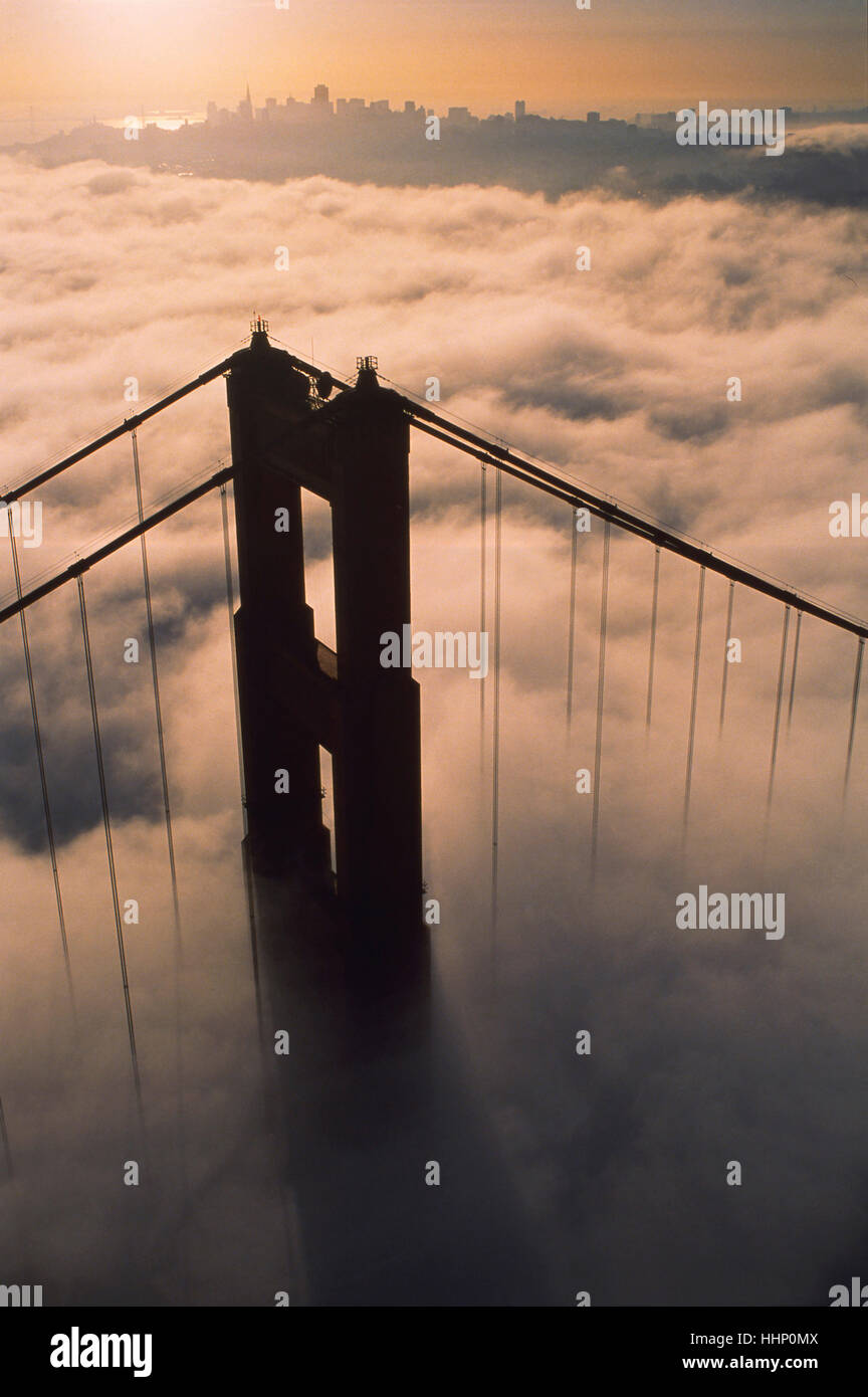 Aerial view of bridge over fog at sunset Stock Photo - Alamy