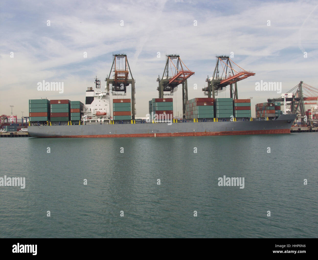 Cranes above cargo containers on freighter Stock Photo