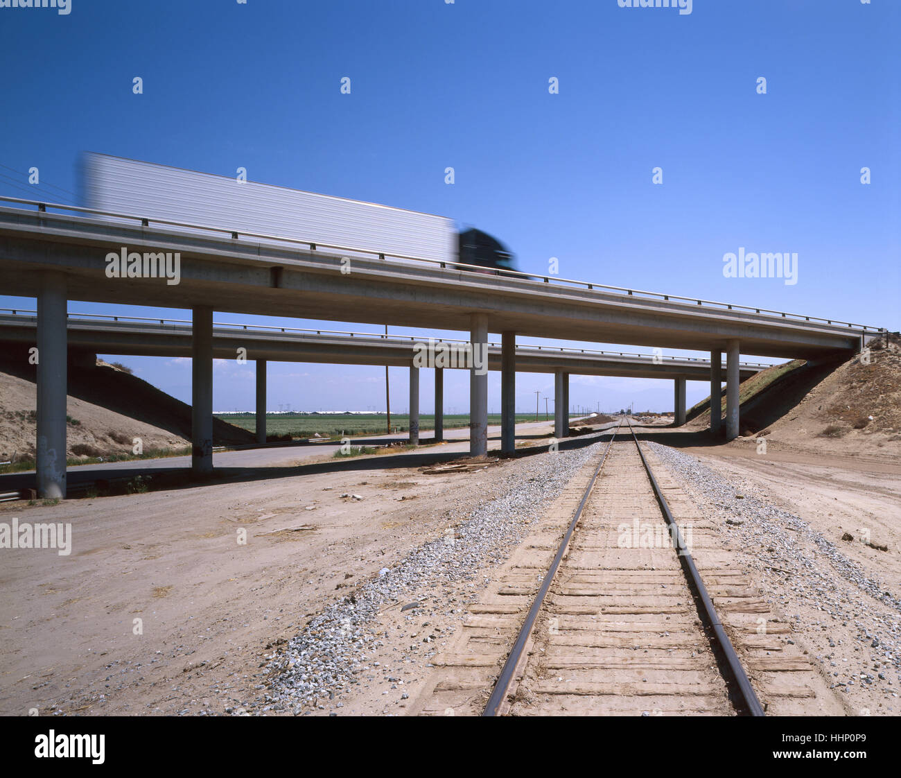 Truck driving on railroad tracks hires stock photography and images
