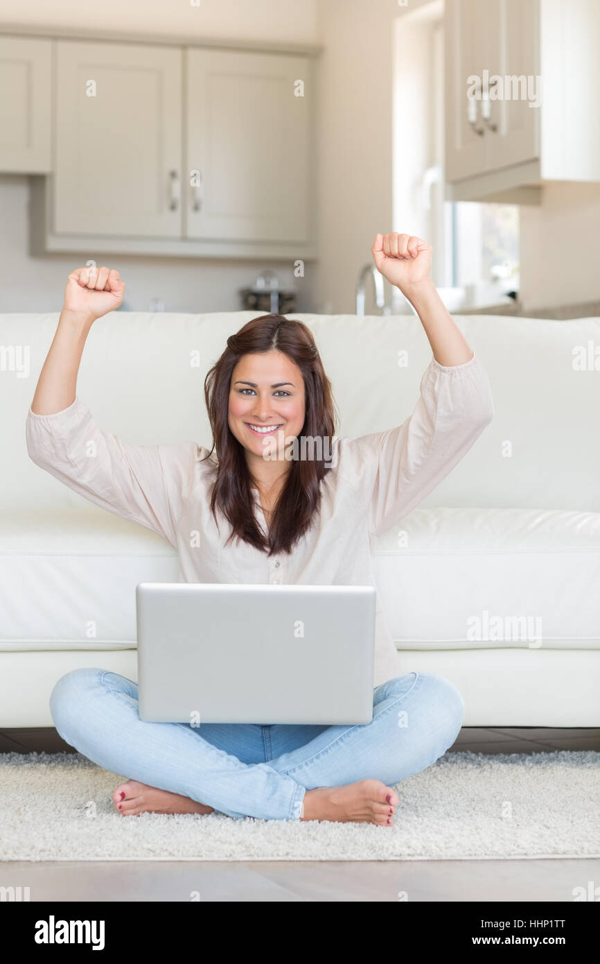 Happy and successful woman raising her hands in front of laptop Stock ...