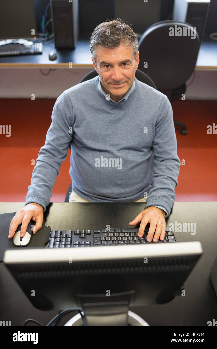 Happy man in computer class using the computer Stock Photo - Alamy