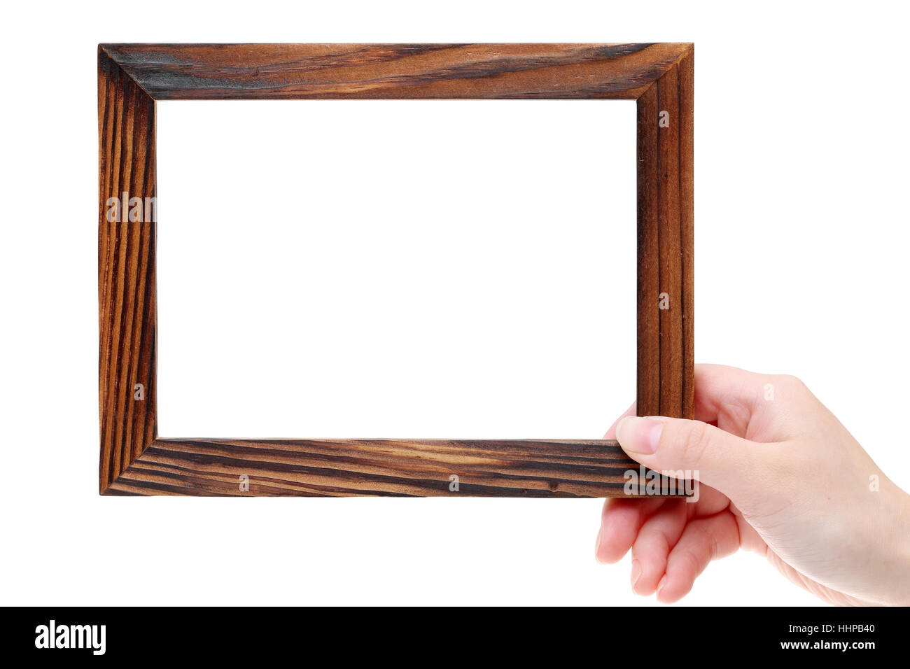 Hand holding wooden picture frame on white background Stock Photo Alamy