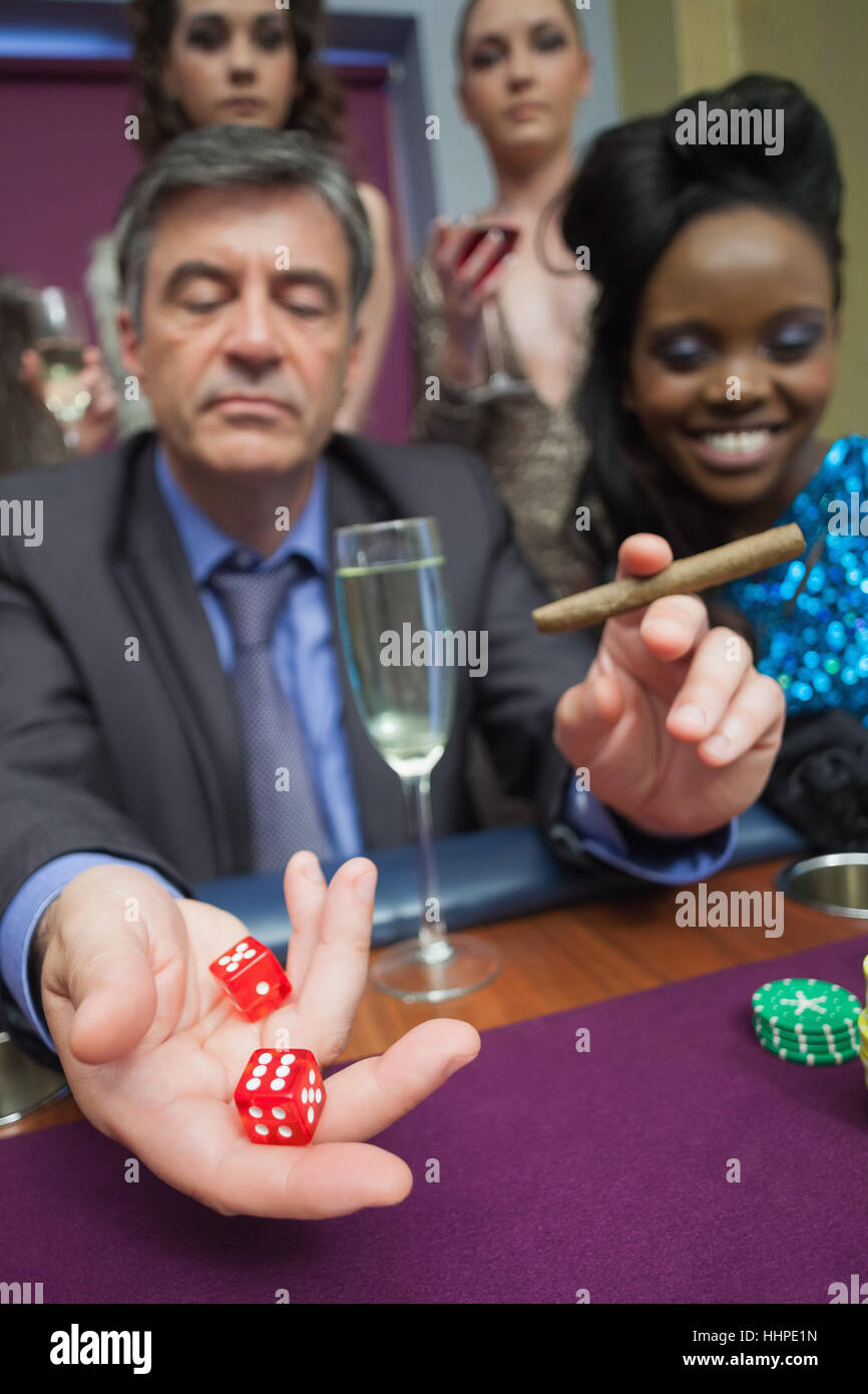 Man throwing dice at craps table hires stock photography and images