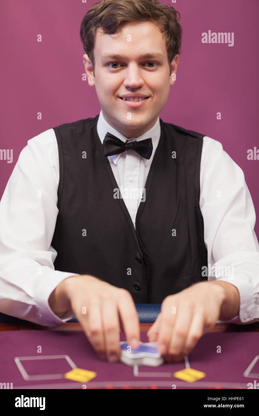 Dealer shuffling cards and smiling Stock Photo Alamy