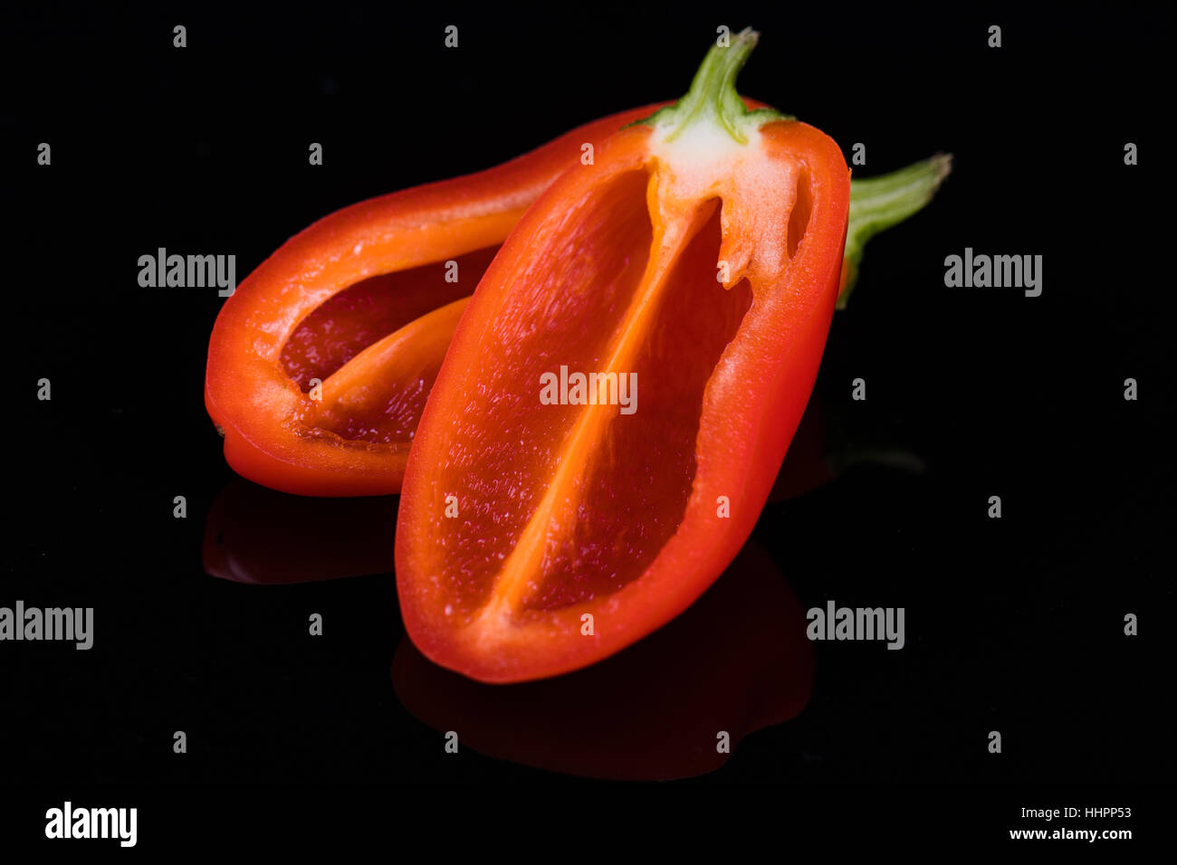 Red sweet peppers on black Stock Photo