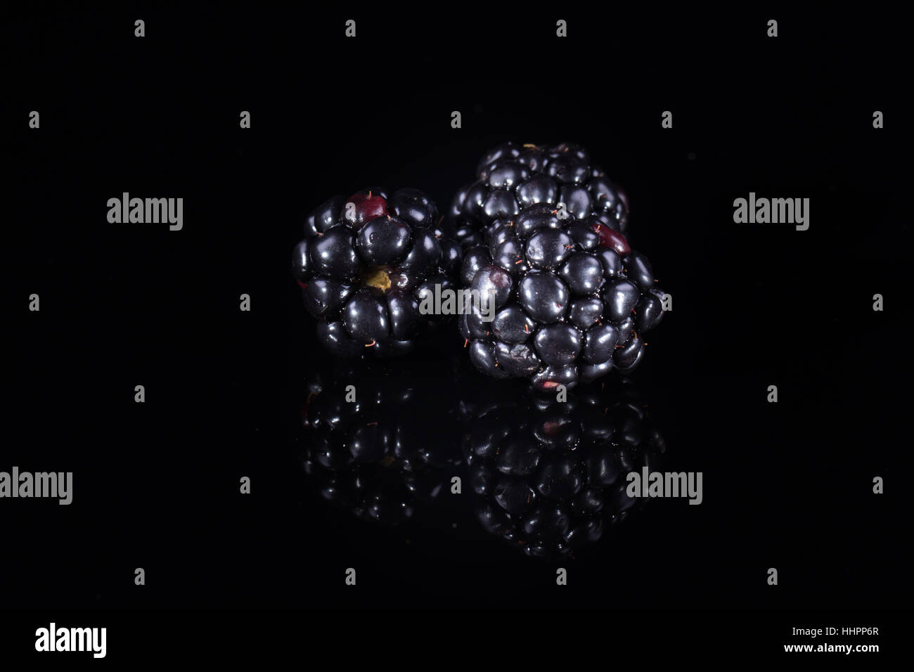 Three blackberries on black Stock Photo