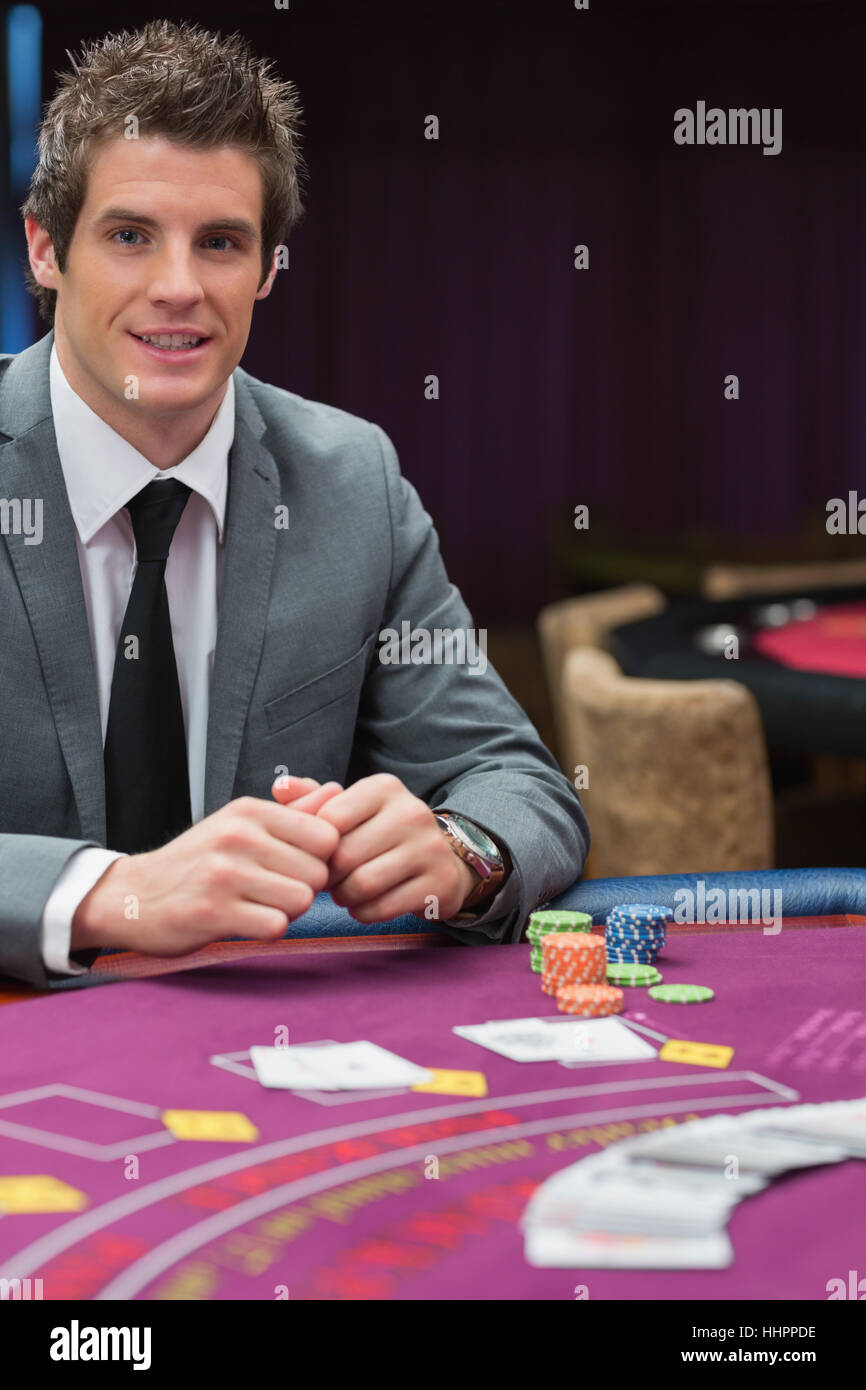 Man sitting at the casino table smiling Stock Photo