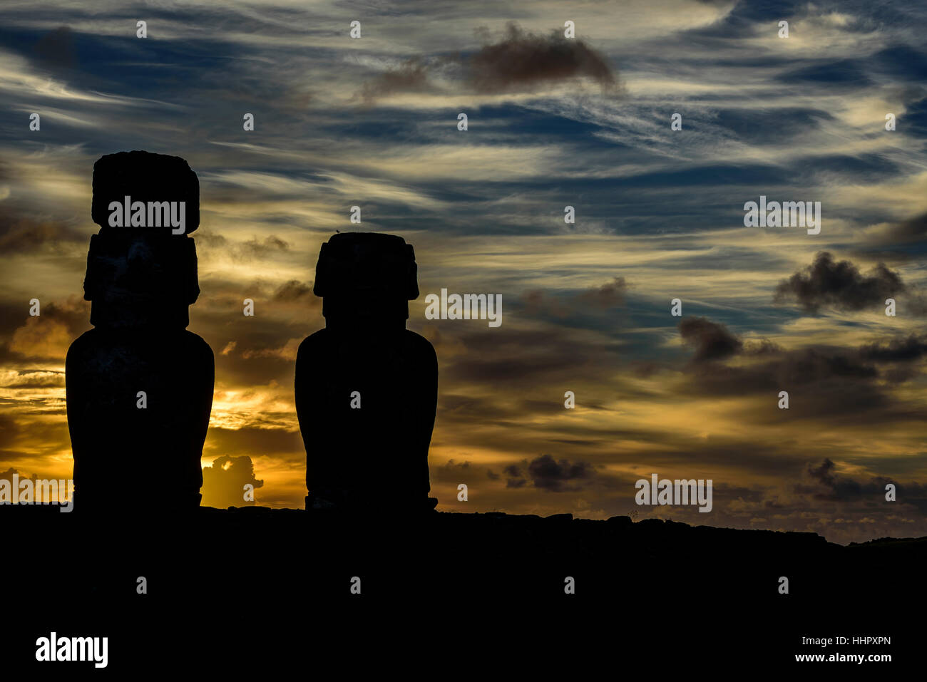 two moai ( statues ) at Tongariki ceremonial platform in easter island , chile.Tongariki is the