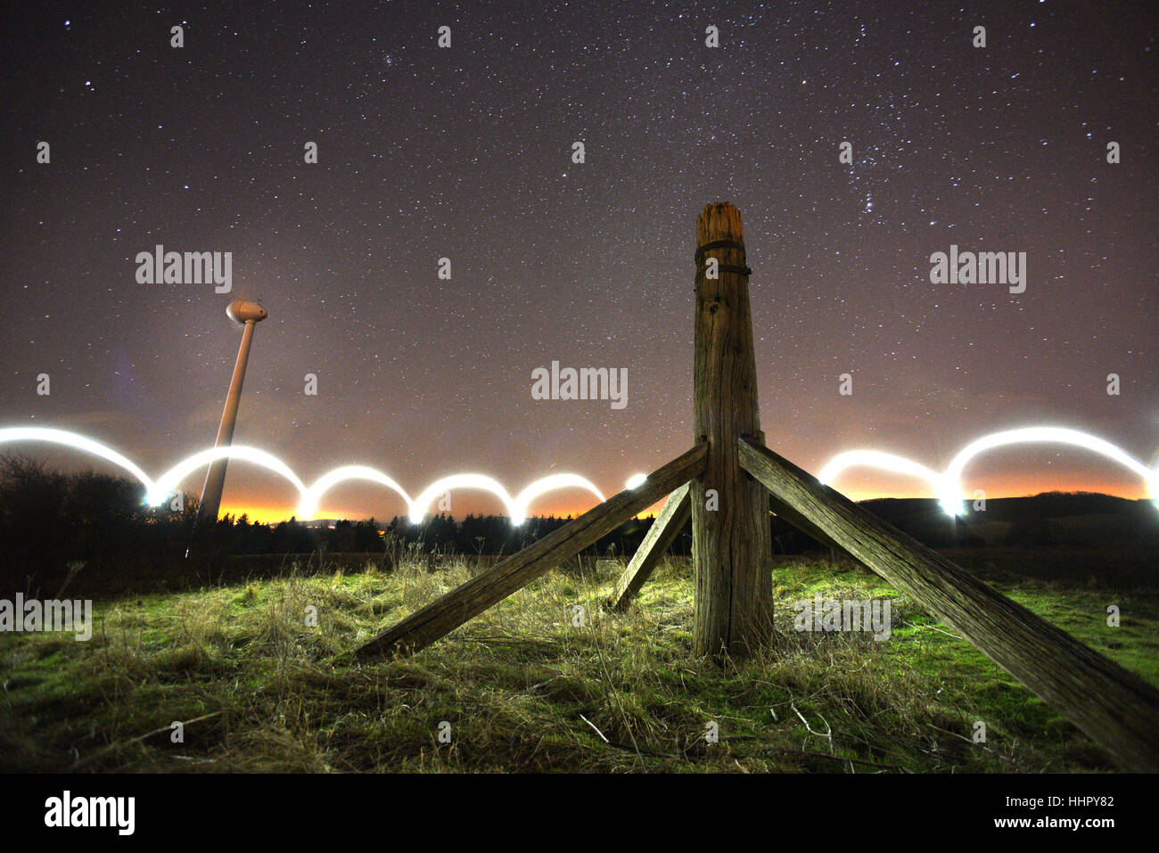 Glyndebourne, UK. 19th January, 2017. Starlight and a mobile phone were used to illuminate Mill Plain on the South Downs, where the remains of an eighteenth century post mill stand alongside the modern wind turbne that helps power world famous Glyndebourne Opera House. Credit: Peter Cripps/Alamy Live News Stock Photo