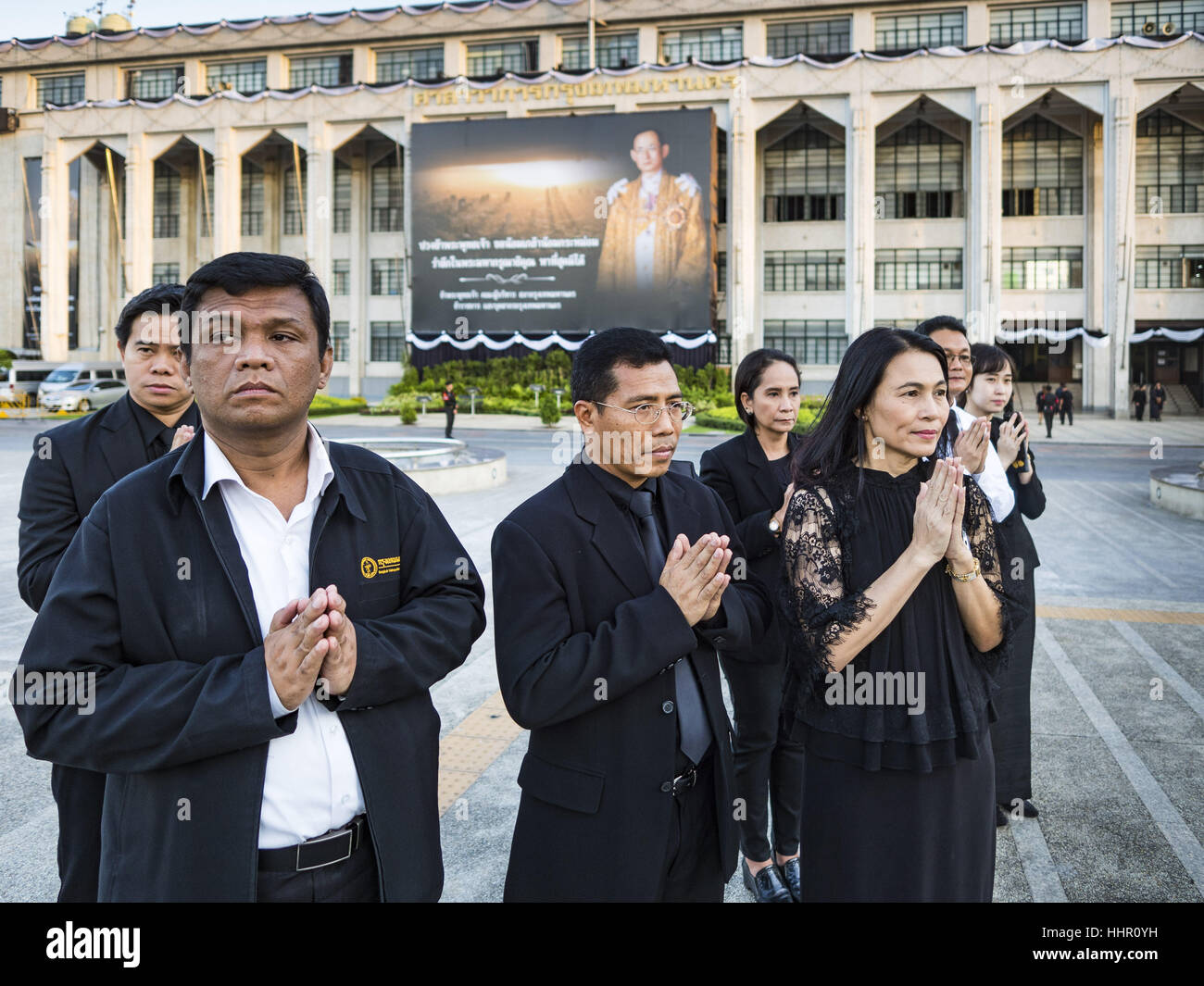 Bangkok, Thailand. 20th Jan, 2017. People pray during a merit making ceremony on the plaza in front of Bangkok's City Hall. Hundreds of municipal workers and civil servants made merit by praying and presenting alms to 89 Buddhist monks Friday to mark 100 days of mourning since the death of revered Bhumibol Adulyadej, the Late King of Thailand. The significance of 89 monks is that the King, who died on October 13, 2016, was a few weeks short of his 89th birthday. Credit: Jack Kurtz/ZUMA Wire/Alamy Live News Stock Photo