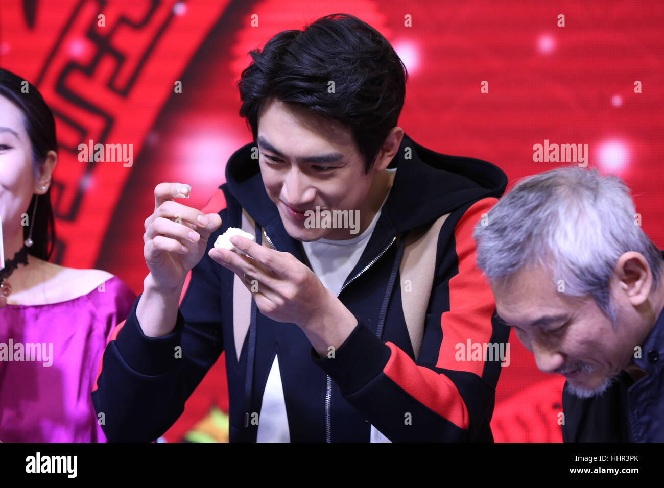 Shenyan, Shenyan, China. 20th Jan, 2017. Shenyang, CHINA-January 20 2017: (EDITORIAL USE ONLY. CHINA OUT) Chinese actor Lin Gengxin makes dumplings during the promotional event.Chinese famous film director Tsui Hark and actor Lin Gengxin promote their latest film 'Journey to the West: The Demons Strike Back' in Shenyang, capital of northeast China's Liaoning Province, January 20th, 2017. Credit: SIPA Asia/ZUMA Wire/Alamy Live News Stock Photo