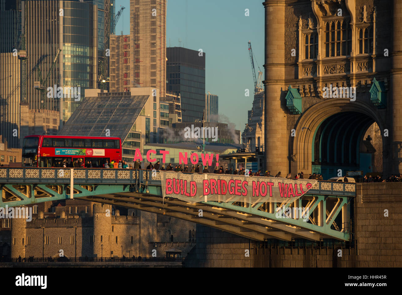 London, UK. 20 January, 2017. On the eve of Donald Trumps inauguration as the 45th President of the United States of America, and in defiance of his politics of hate and division, ’Bridges not walls’ dropped banners from many bridges around the World including the iconic Tower Bridge in London. David Rowe/Alamy Live News Stock Photo