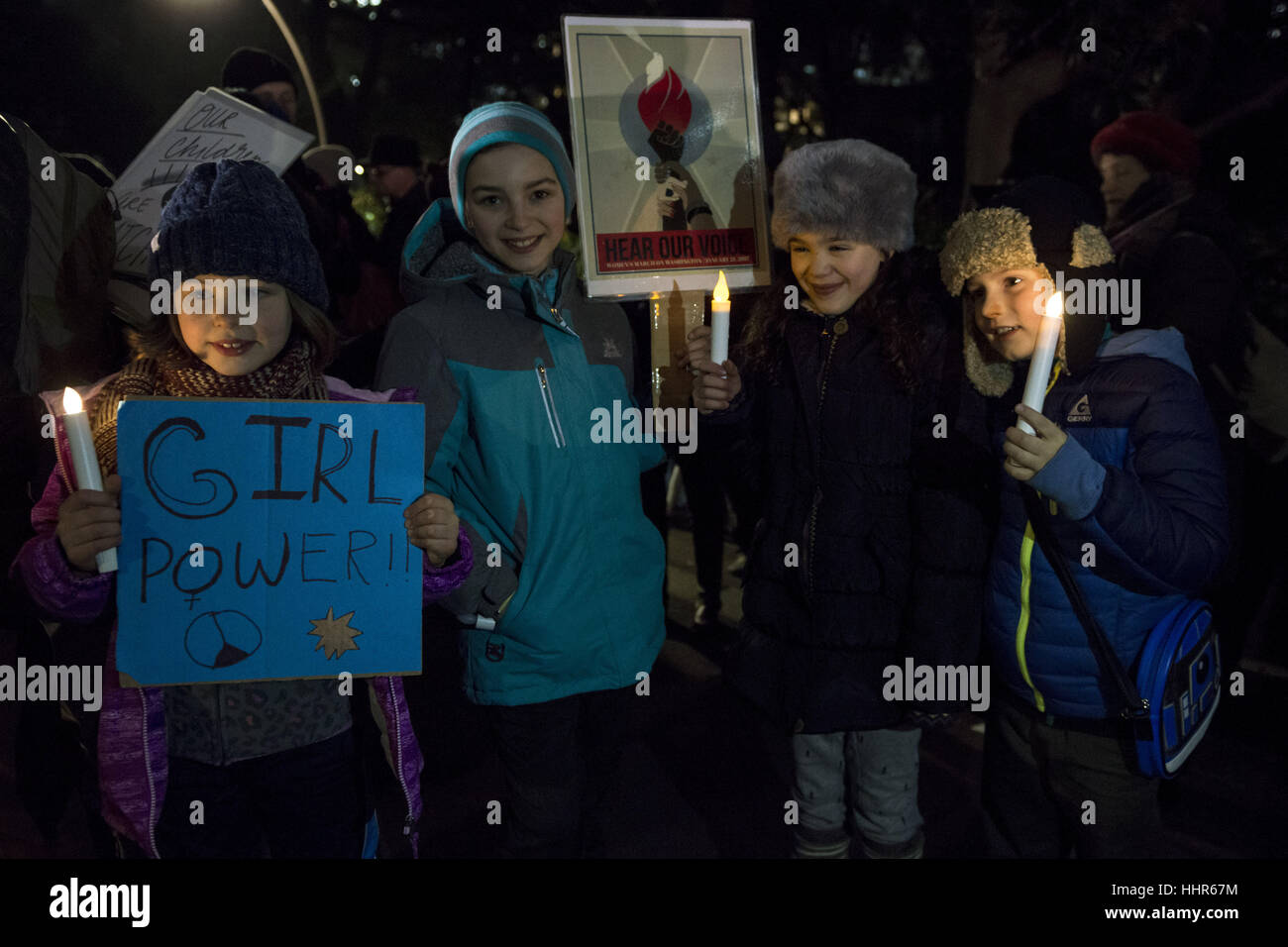 Tokyo, Japan. 20th Jan, 2017. Young US citizens living in Japan hold placards during a vigil to thank outgoing President Barack Obama and reject US President-elect Donald Trump before his inauguration at a park in Tokyo, Japan. Around 200 people participated to the rally organised by Democrats Abroad Japan and held a few hours before US President-elect Trump's inauguration. Credit: Alessandro Di Ciommo/ZUMA Wire/Alamy Live News Stock Photo
