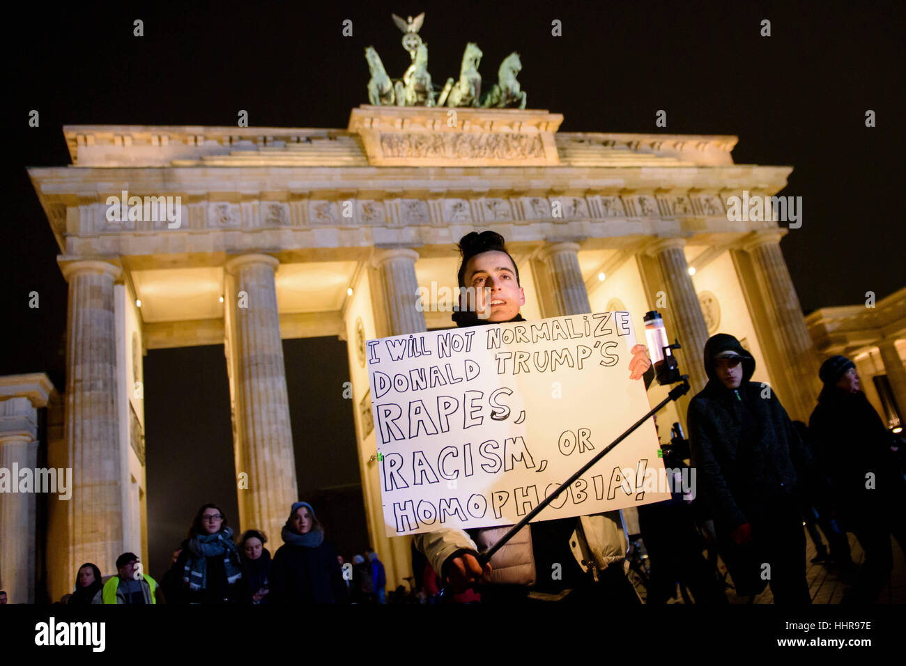 Berlin, Germany. 20th Jan, 2017. A protestor at the demonstration 'Nein zum weltweiten Trumpismus' (lt. No to worldwide Trumpism) from the initiative 'The Coalition' with a placard reading 'I will not normalize Donald Trump's rapes, racism, or homophobia' in Berlin, Germany, 20 January 2017. Photo: Gregor Fischer/dpa/Alamy Live News Stock Photo