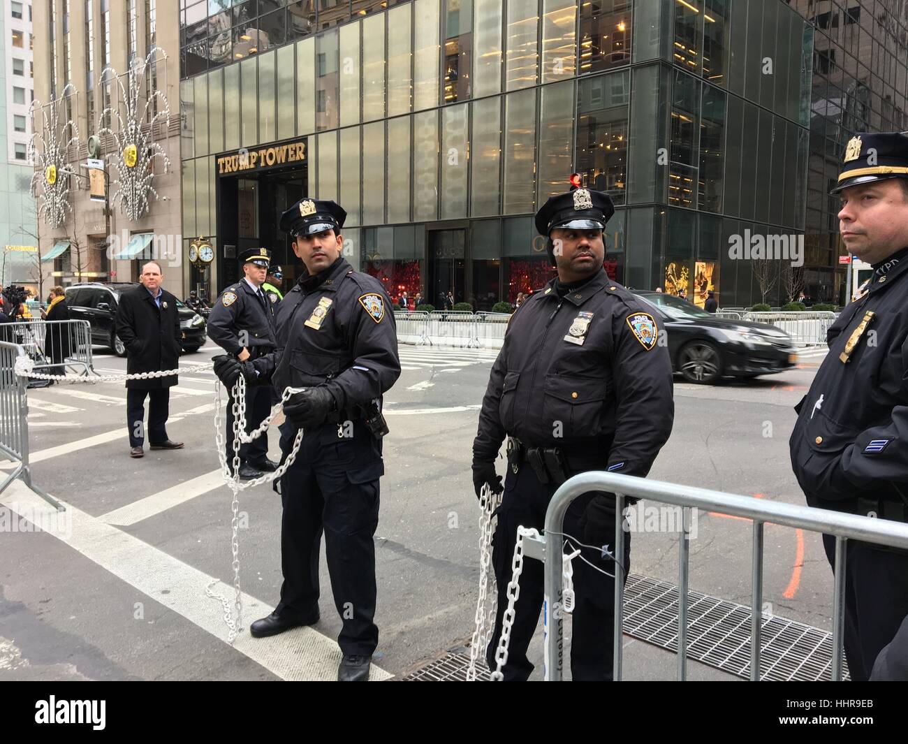 New York, NY, USA. 20th Jan, 2017. New York Police Department (NYPD) officers stand guard ready to cordon off street with chains as people protest in front of Trump Tower on the Inauguration Day on which Donald Trump took office as the 45th President of the United in New York, New York on January 20, 2017. Credit: Rainmaker Photo/Media Punch/Alamy Live News Stock Photo