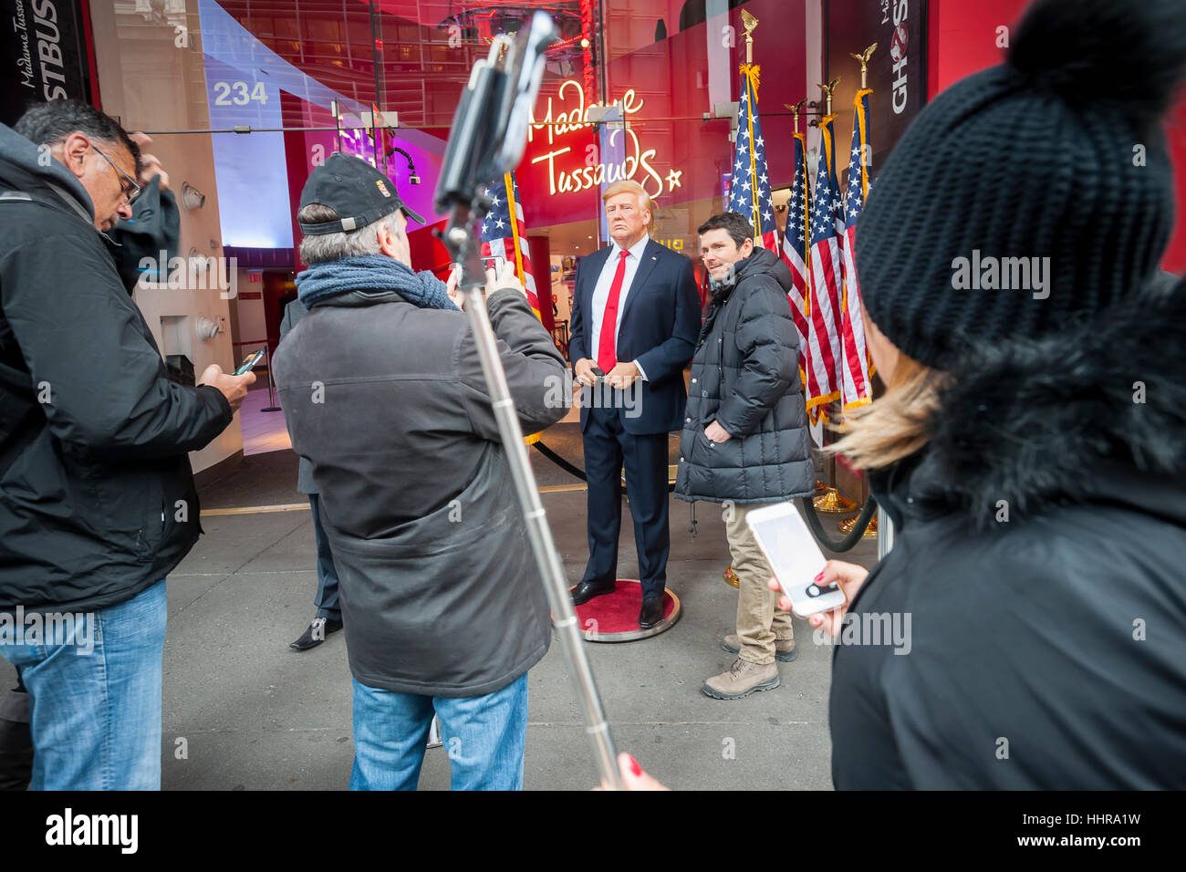 New York, USA. 20th Jan, 2017. Tourists pose for photographs with a wax figure of President Donald Trump in front of Madame Tussaud's Wax Museum in Times Square after the inauguration of Trump as the 45th president of the United States on Friday, January 20, 2017. ( © Richard B. Levine) Credit: Richard Levine/Alamy Live News Stock Photo