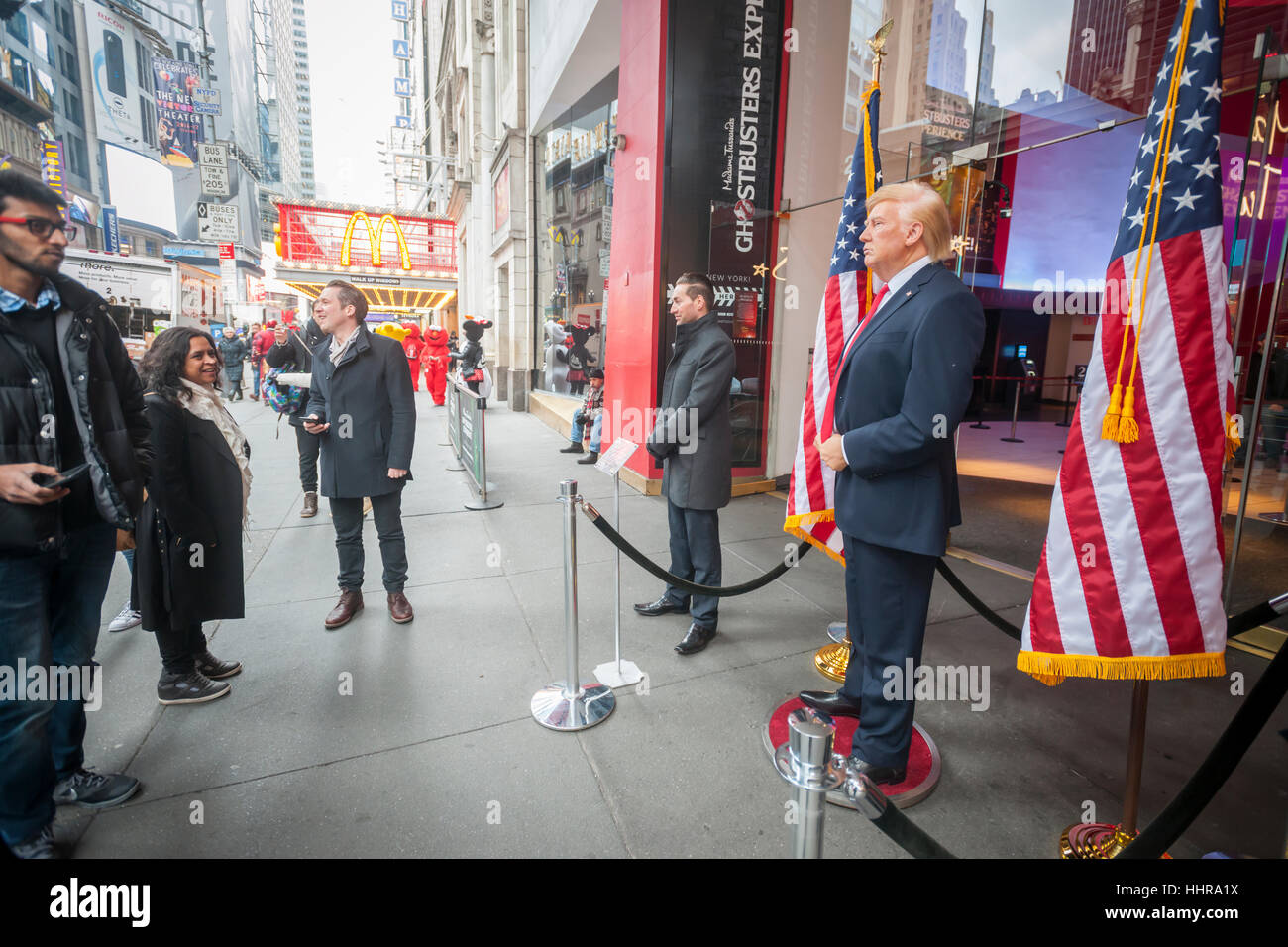 New York, USA. 20th Jan, 2017. Tourists pose for photographs with a wax figure of President Donald Trump in front of Madame Tussaud's Wax Museum in Times Square after the inauguration of Trump as the 45th president of the United States on Friday, January 20, 2017. ( © Richard B. Levine) Credit: Richard Levine/Alamy Live News Stock Photo