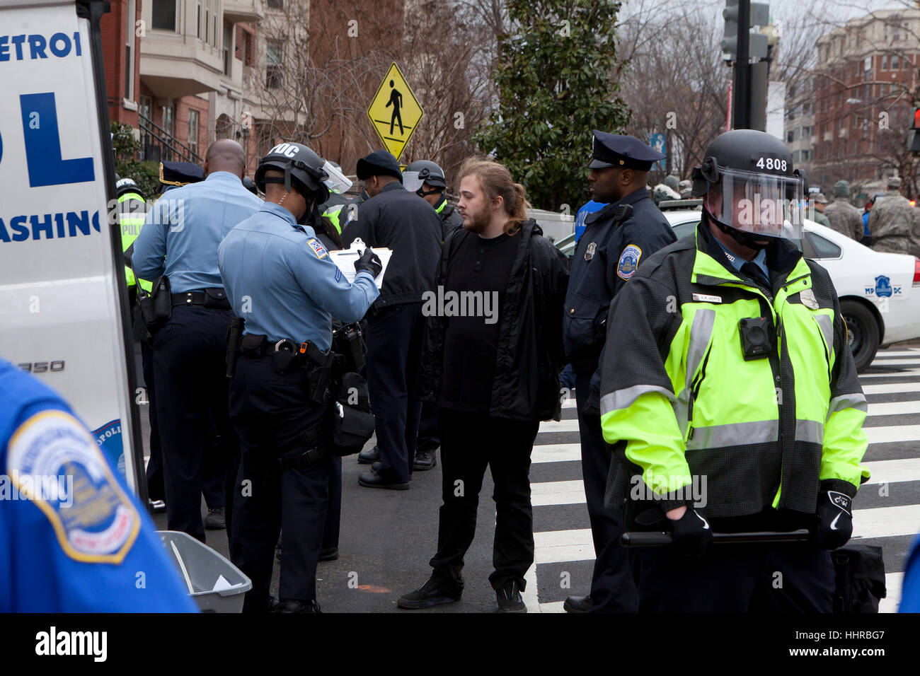Washington, USA. 20th January, 2017.  Thousands of anti-Trump protesters march just outside of the presidential inauguration security perimeter. Many protesters clashed with riot police. Credit: B Christopher/Alamy Live News Stock Photo