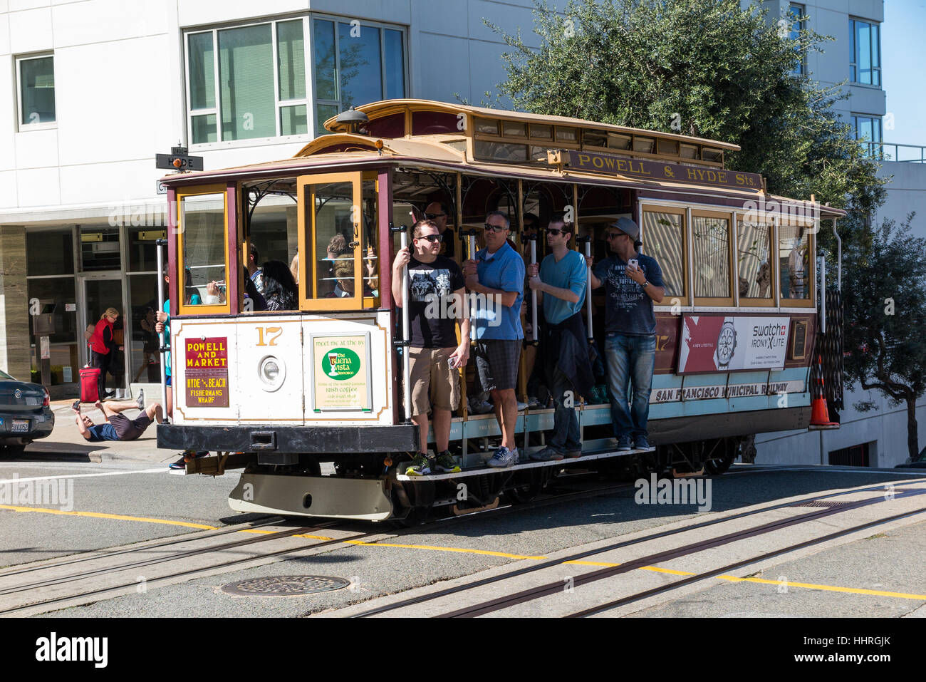 People riding a PowellHyde cable car / trolley in San Francisco
