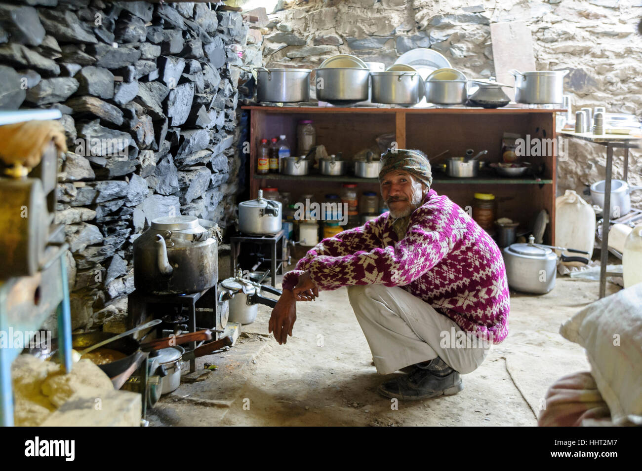 Indian man preparing tea and other hot drinks in a typical rudimentary coffee shop in the Himalayas, India Stock Photo