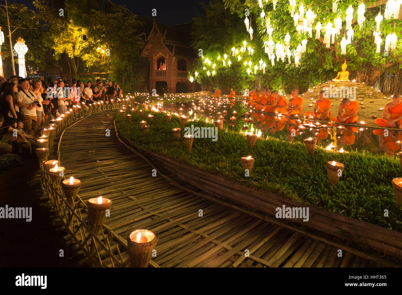 Chiang Mai, Thailand - November 14, 2016: buddhist monk sitting at waterside with candle light in Yeepeng festival at Puntao temple in Chiang Mai, Tha Stock Photo