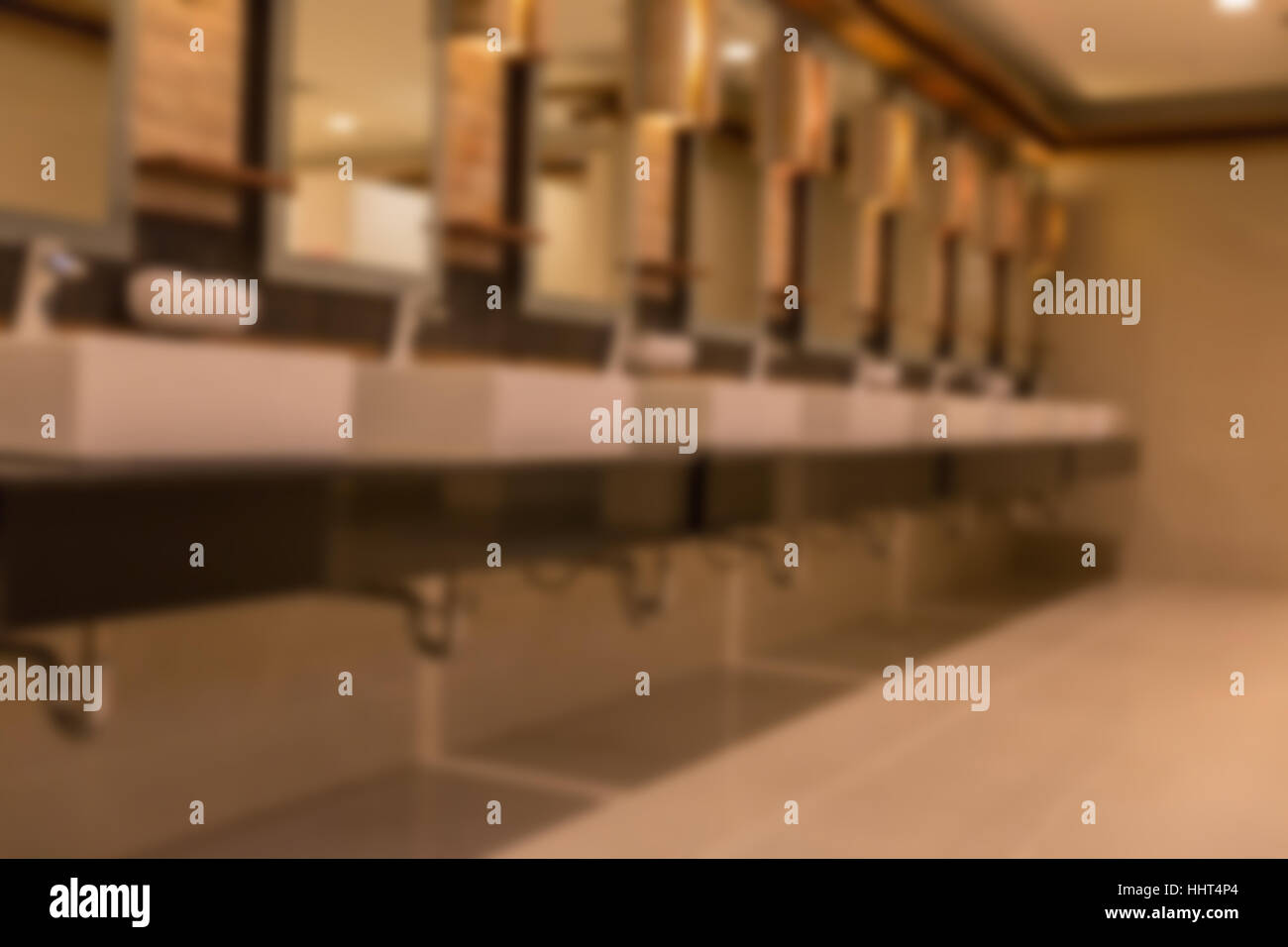 blurred background of faucet and sink in public bathroom restroom