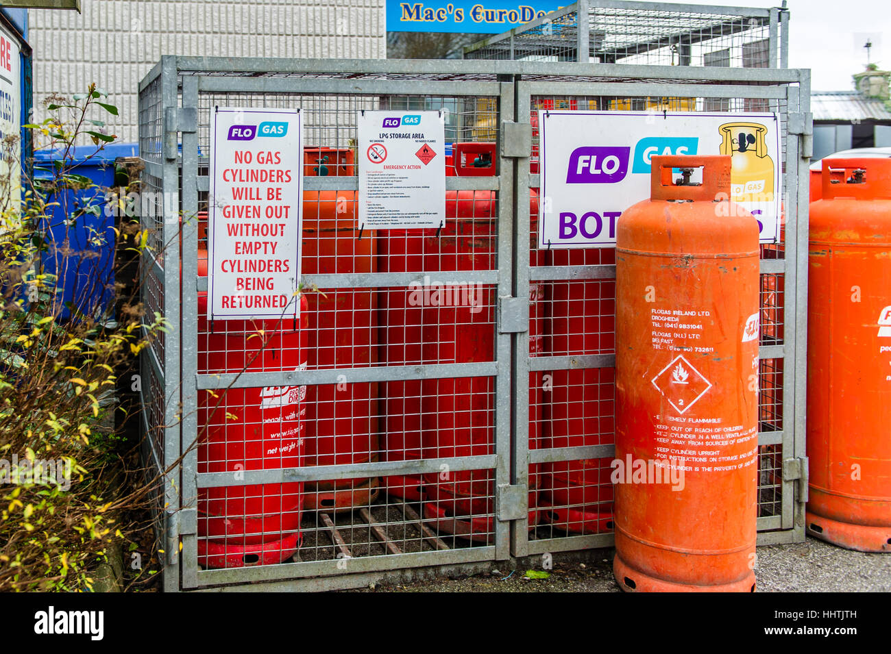 A cage with propane gas bottles for sale on a garage forecourt in Ireland. Stock Photo