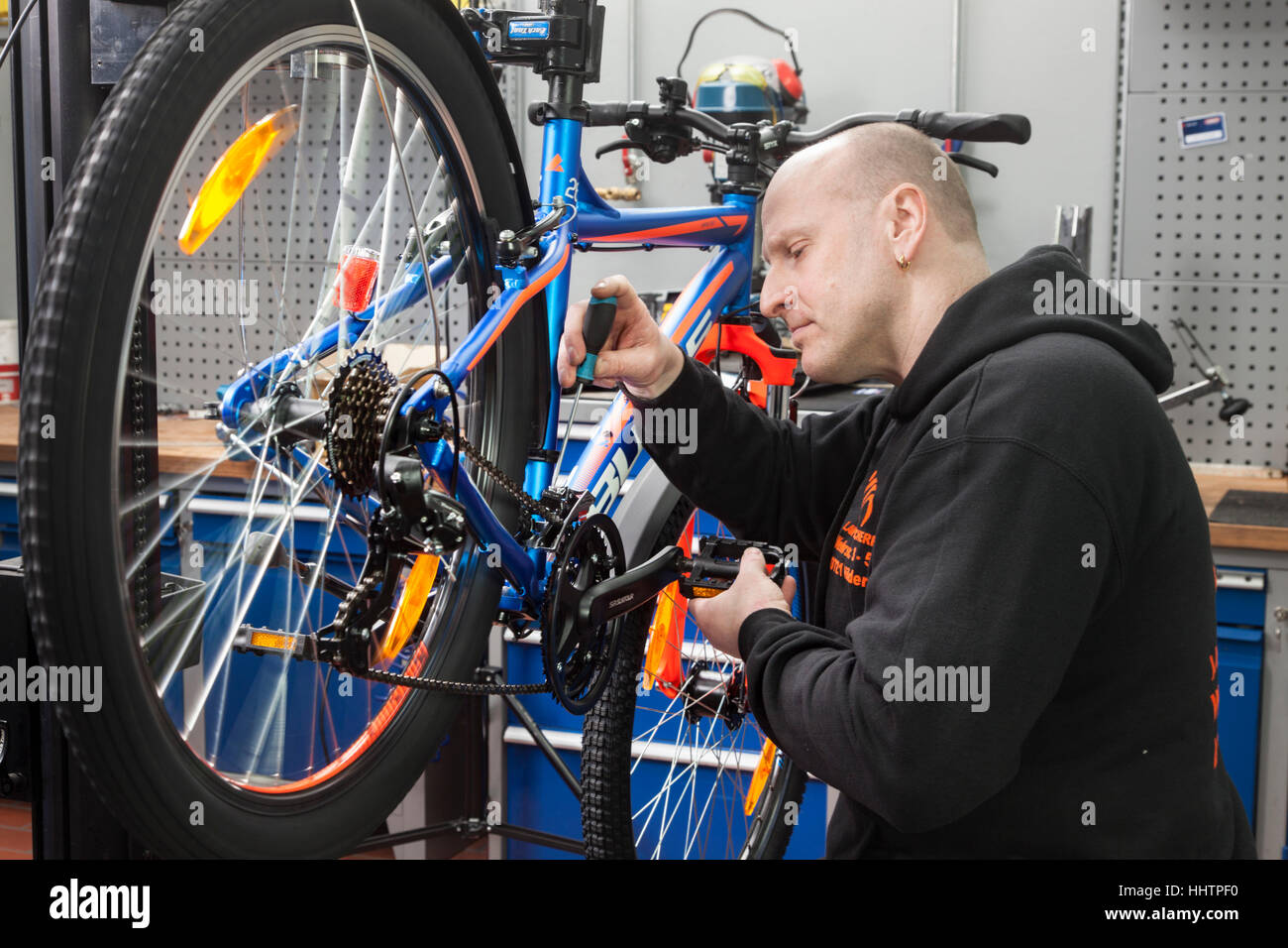A bicycle mechanic during the inspection at a mountain bike in his