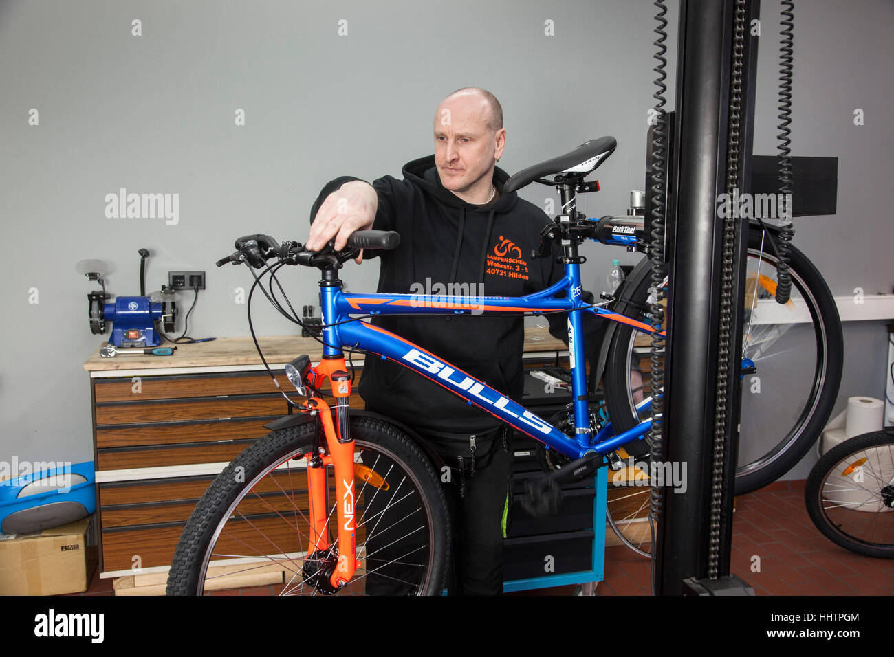 A bicycle mechanic during the inspection at a mountain bike in his