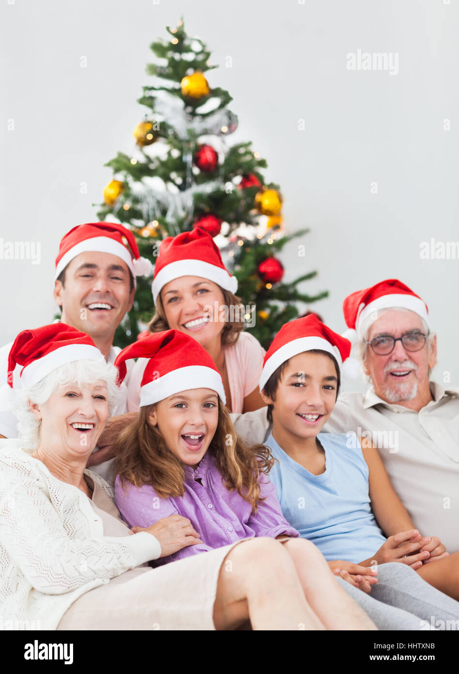 Happy family sitting on couch at christmas Stock Photo