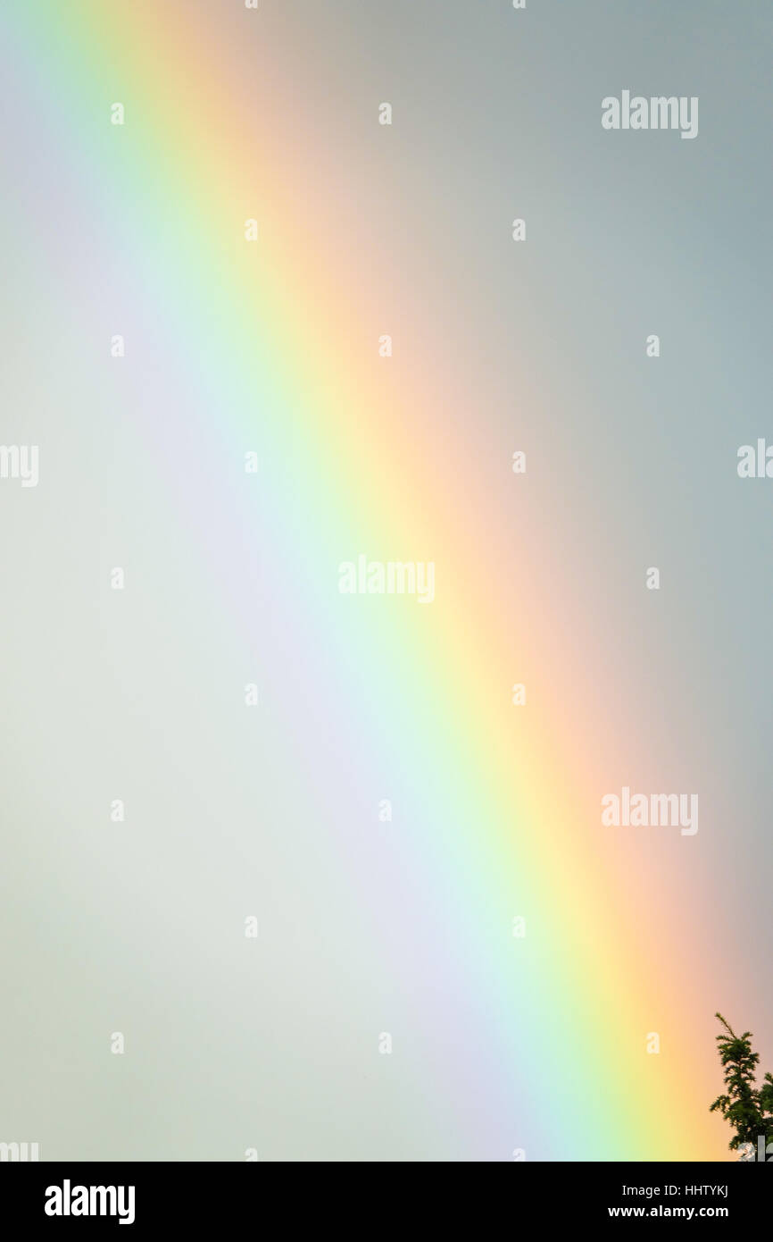 Large rainbow over the cloudy and rainy sky Stock Photo - Alamy
