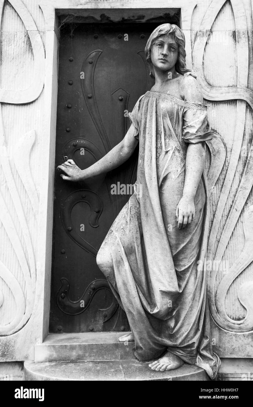 Statue at a Tomb in Recoleta Cemetery, Buenos Aires, Argentina, depicting the Passage to Death. Stock Photo