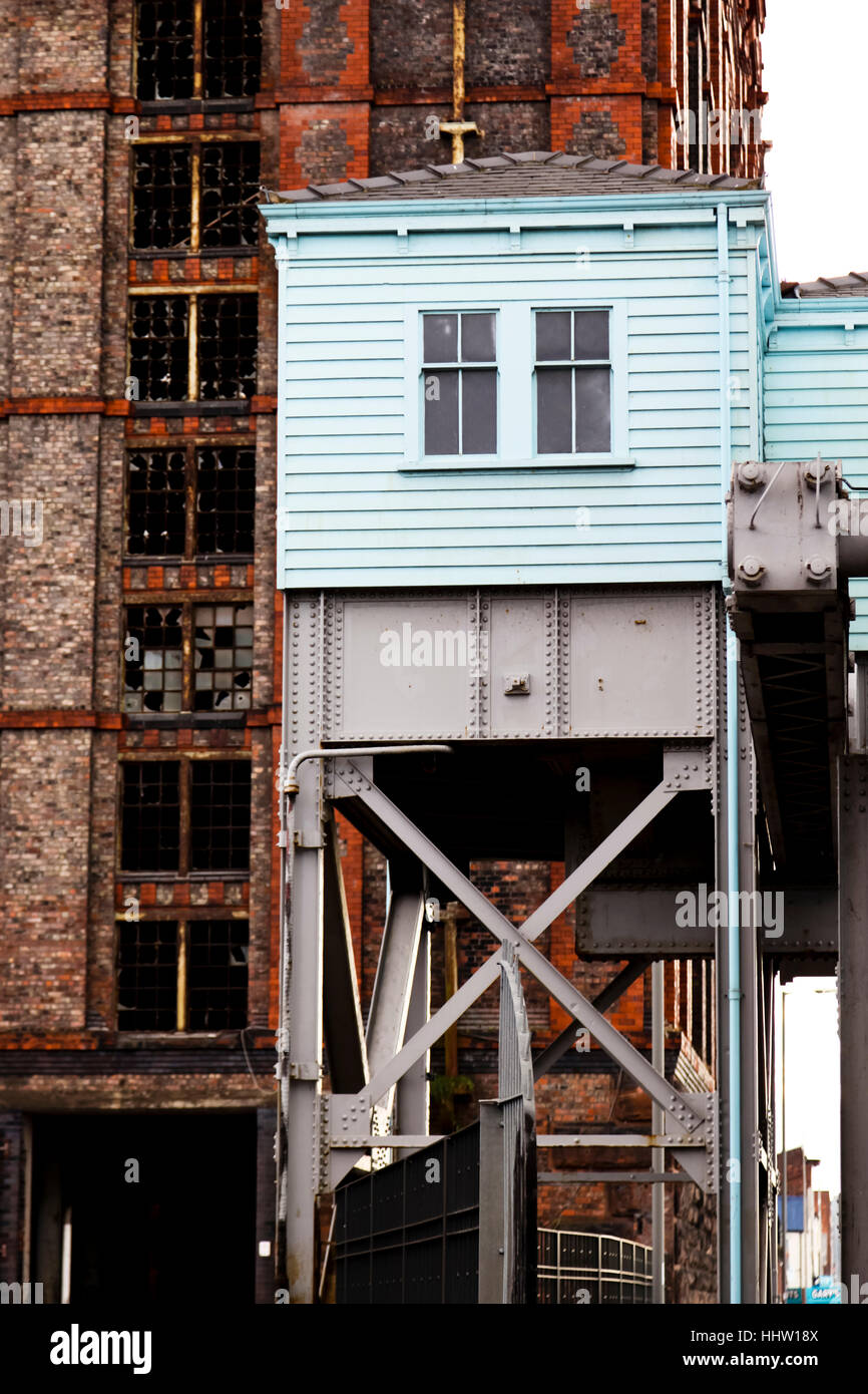 Part of the machine room of the Stanley Docks bascule Bridge with the Tobacco Warehouse in the background Stock Photo