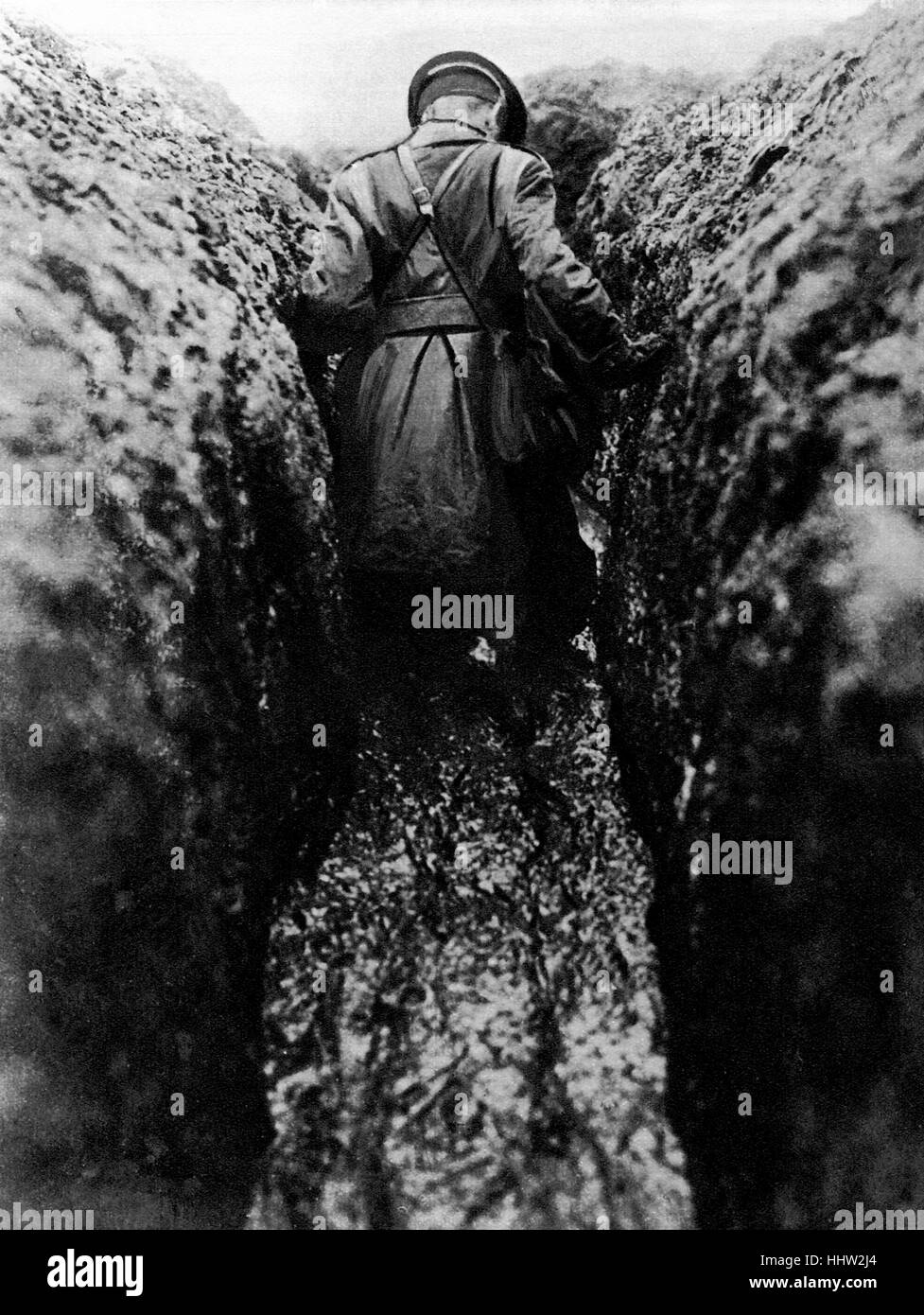 Winter on the Western Front, an officer wading through a trench of half frozen mud. First World War, 1916 Stock Photo