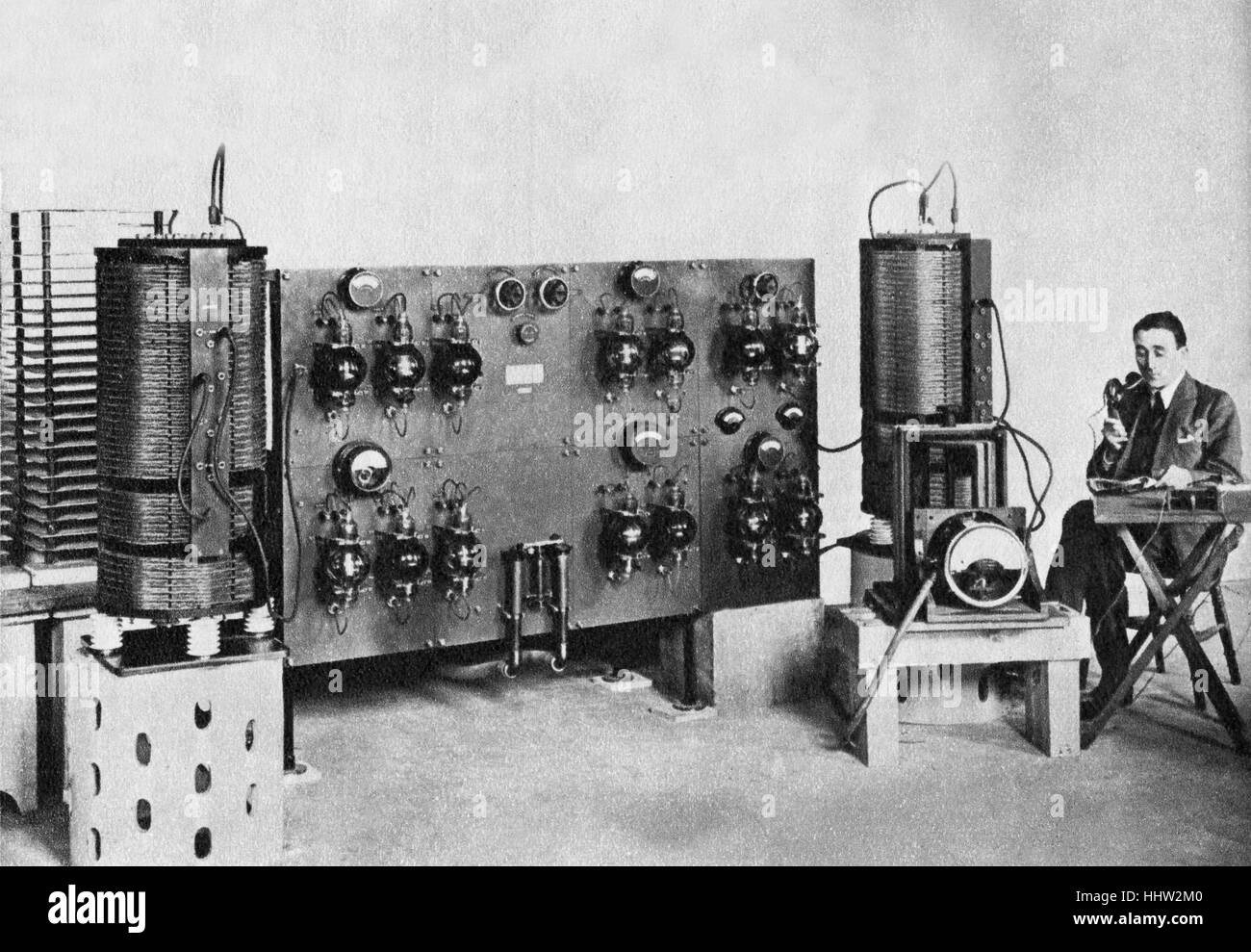 Early radio broadcast at Chelmsford - the news bulletin is being read from an evening newspaper. 1920 Stock Photo