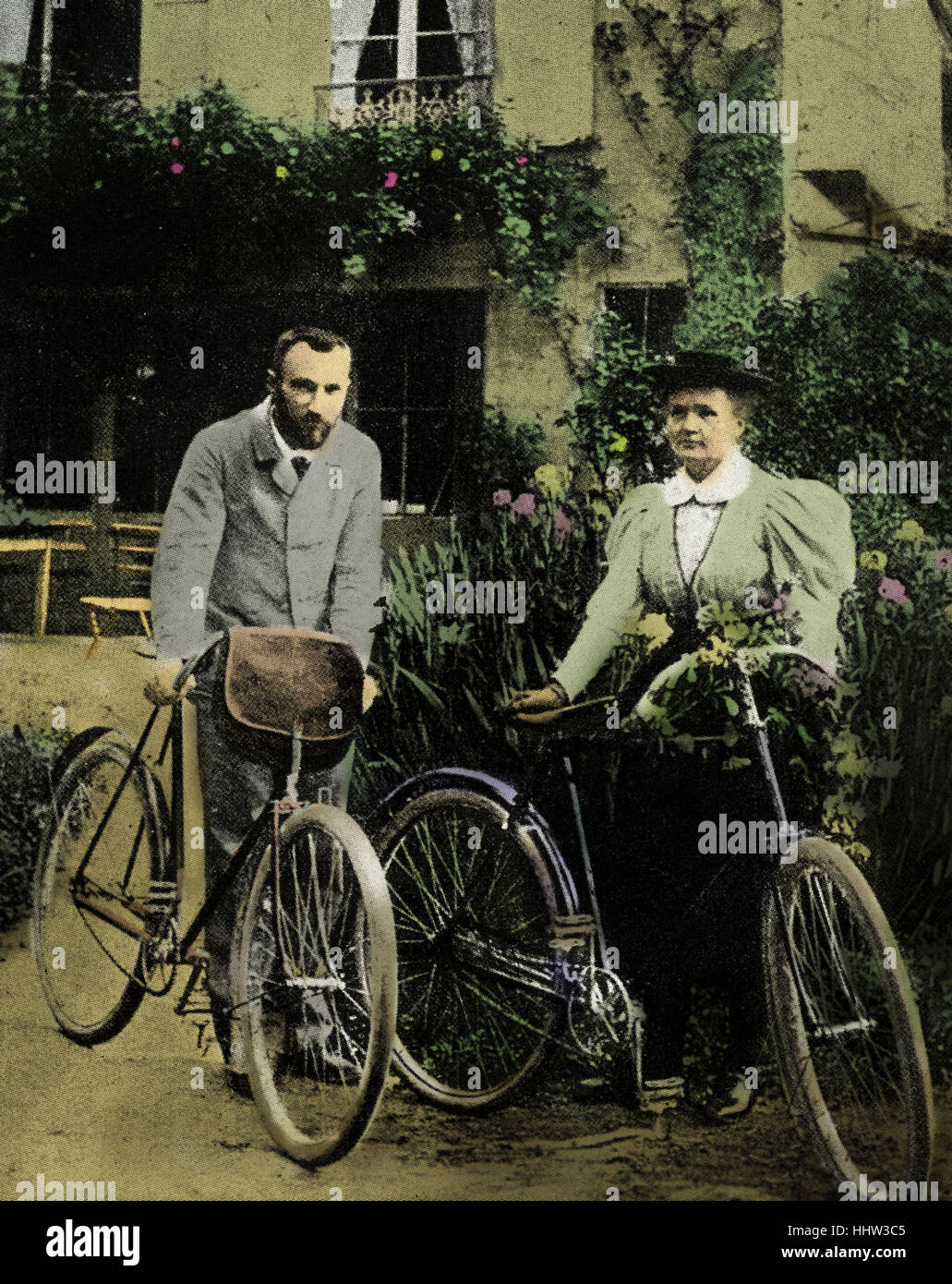 Pierre and Marie Curie with the bicycles on which, during their early married life, the roamed the roads of France together. MC: Polish-born French physicist and pioneer in radioactivity, 7 November 1867 – 4 July 1934. PC: French physicist and pioneer in radioactivity, 15 May 1859 – 19 April 1906. Stock Photo