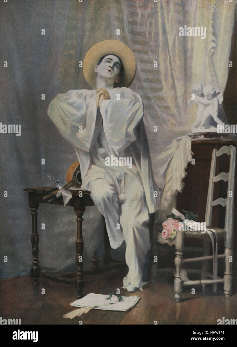 Pierrot Poete, a character of mime and Commedia dell'Arte theatre. His character is that of a sad clown, pining for the love of Columbine. Illustration by Alexis Vollon, French artist, 1865-1945. Stock Photo