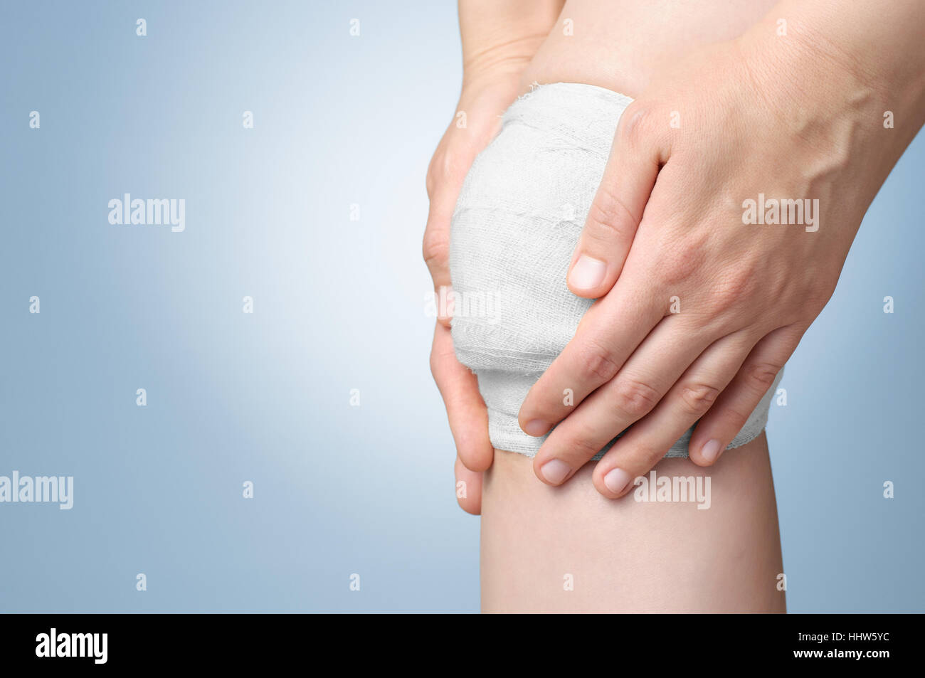 Injured painful knee with white gauze bandage Stock Photo Alamy